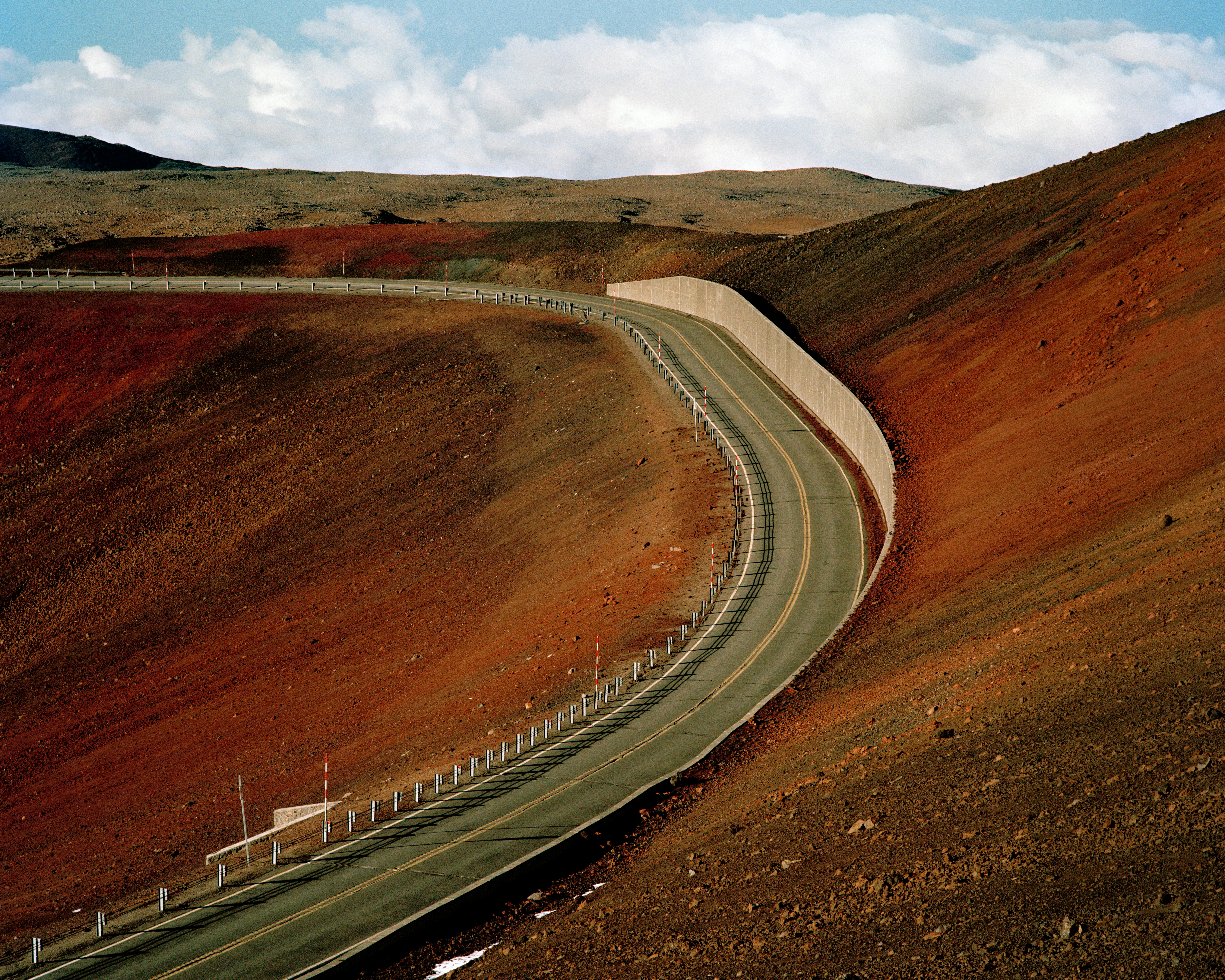 A road cuts through red volcanic soil in Hawai'i.