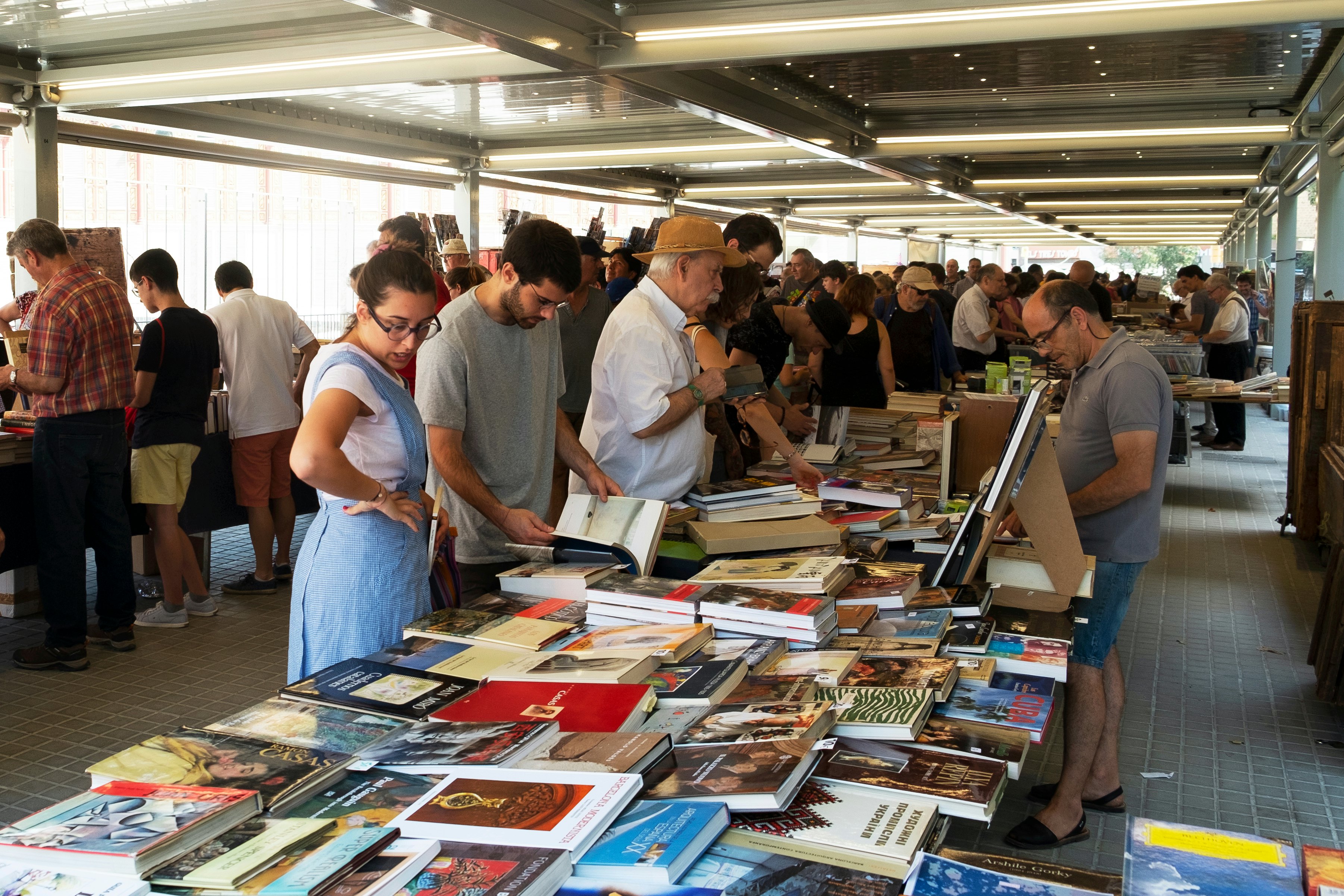 Customers at the stalls of the secondhand book market at the Mercat de Sant Antoni public market in Barcelona, Spain, which is set up every Sunday morning