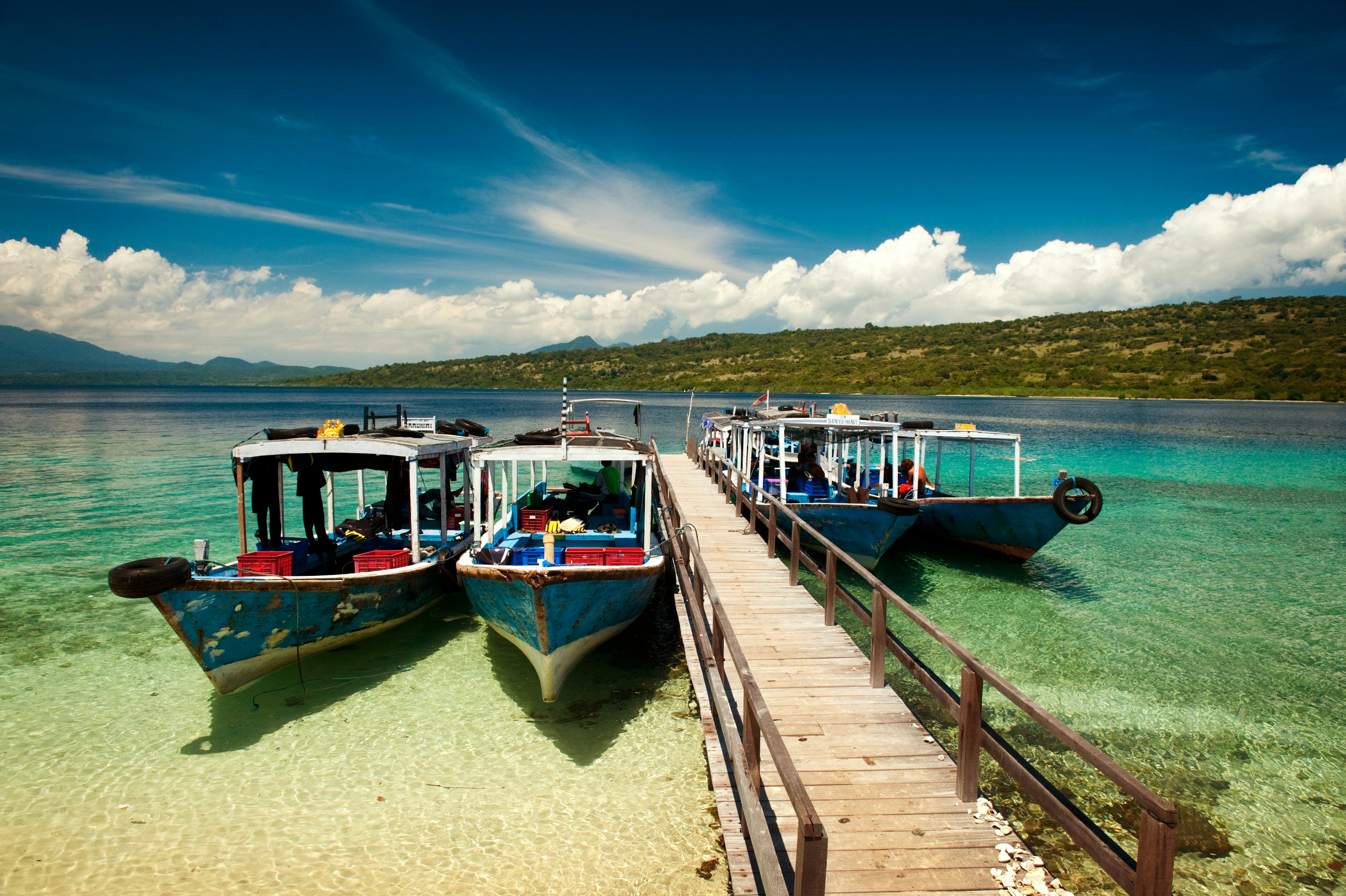Dive boats wait at the dock on Menjangan Island, Bali, before taking SCUBA tourists out on the magnificent reefs in Bali Barat National Park.