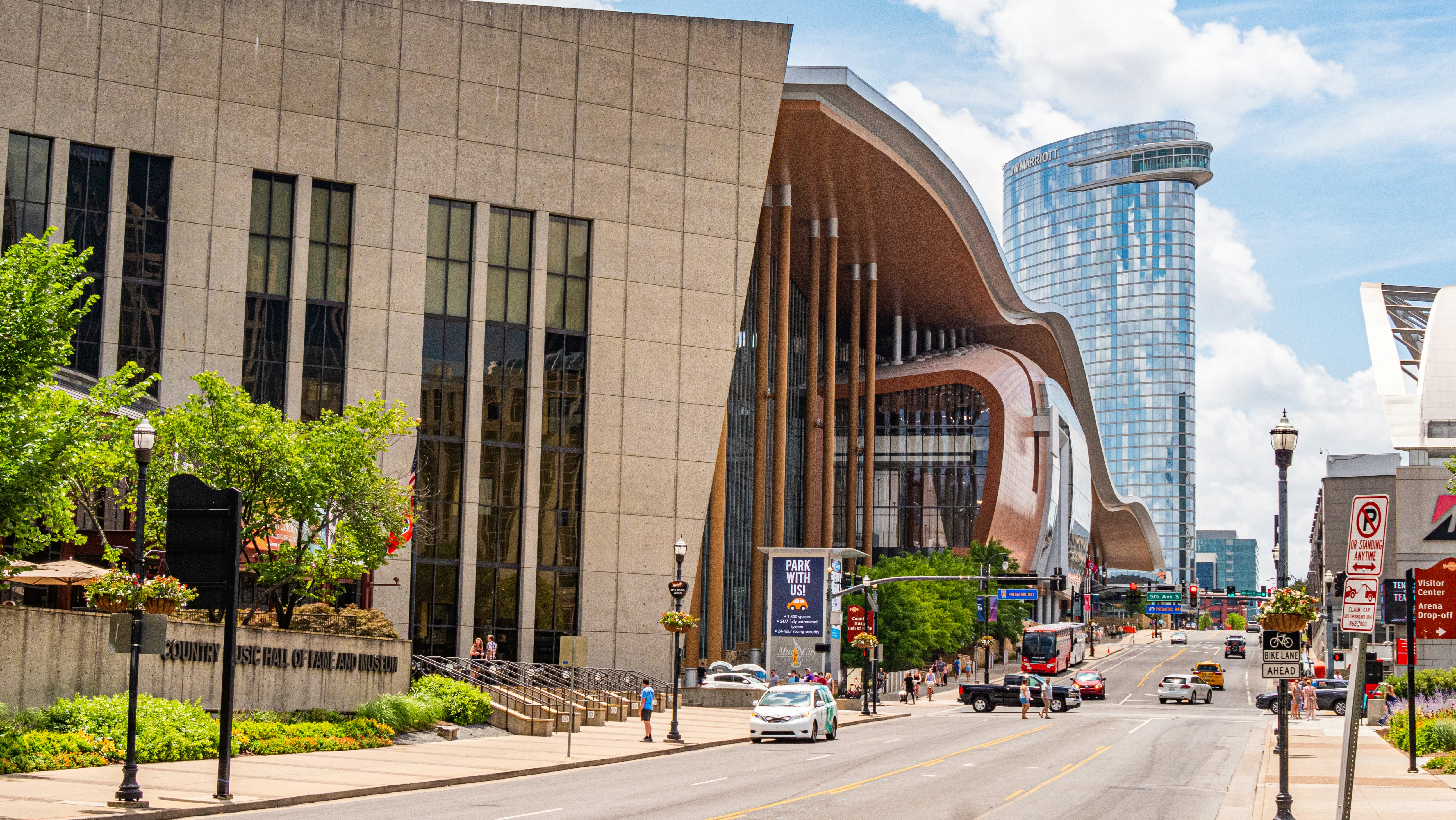 A large, sleekly designed building along a city street