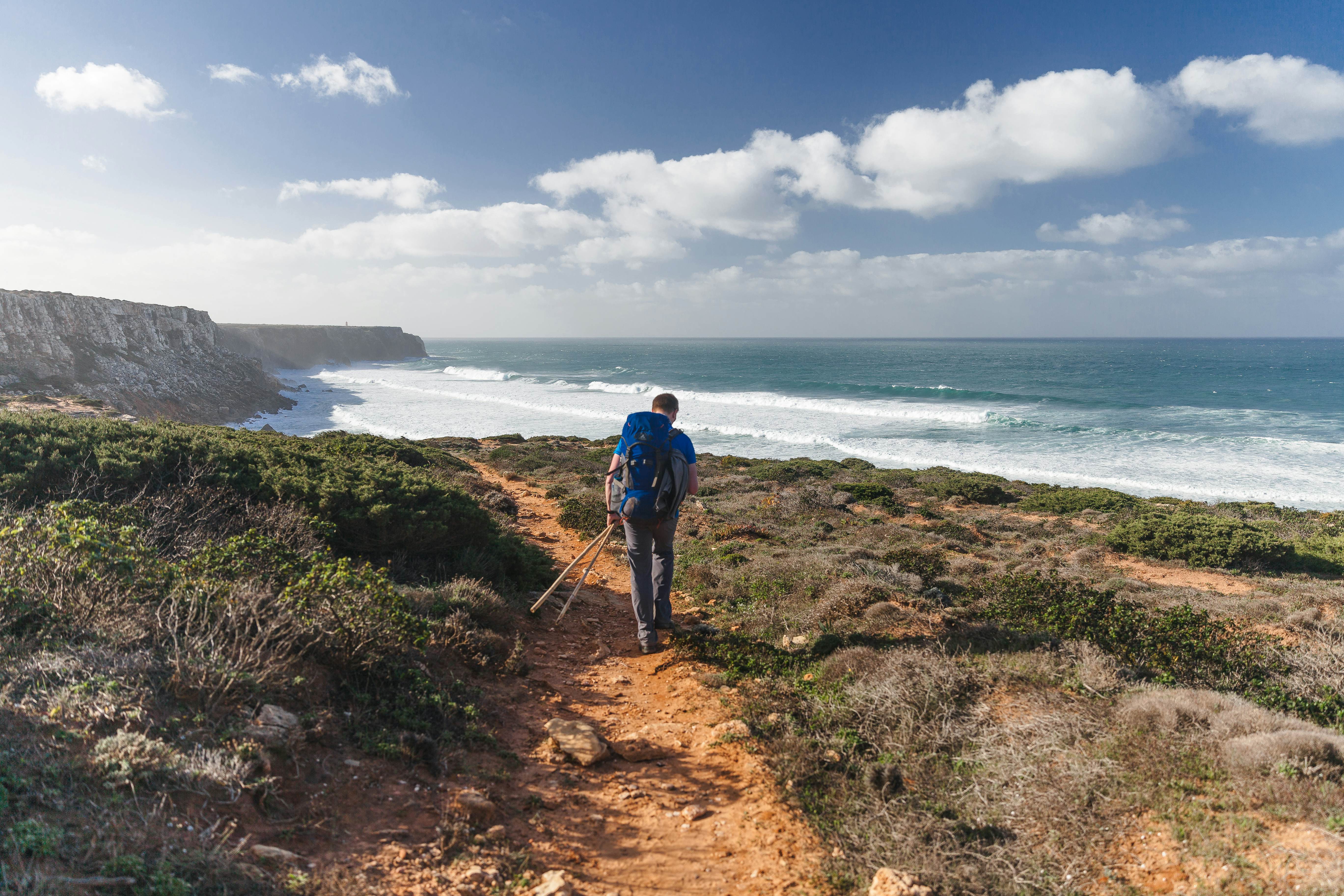 Hihing man on the coastal trail. Backpacker, solo traveler, active lifestyle. Rota Vicentina, Fishermen's trail, Portugal.  License Type: media  Download Time: 2023-07-18T16:04:05.000Z  User: lonelyplanetmedia  Is Editorial: No  purchase_order:   