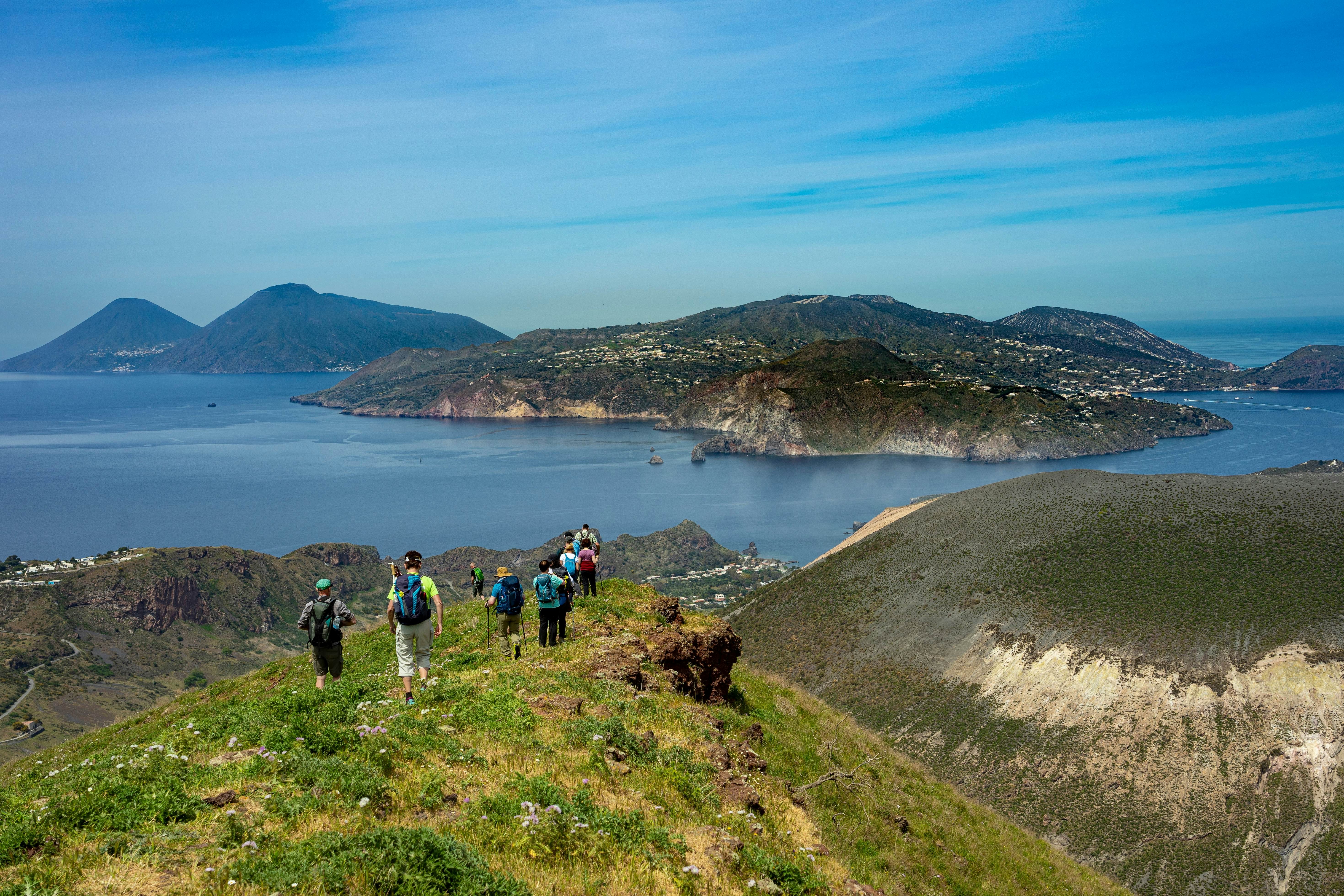 Sicily: hike up the Monte Saraceno mountain on Vulcano with a view of blooming spring meadows and the sea - travel group of hikers  License Type: media  Download Time: 2022-12-22T01:53:44.000Z  User:   Is Editorial: No  purchase_order: