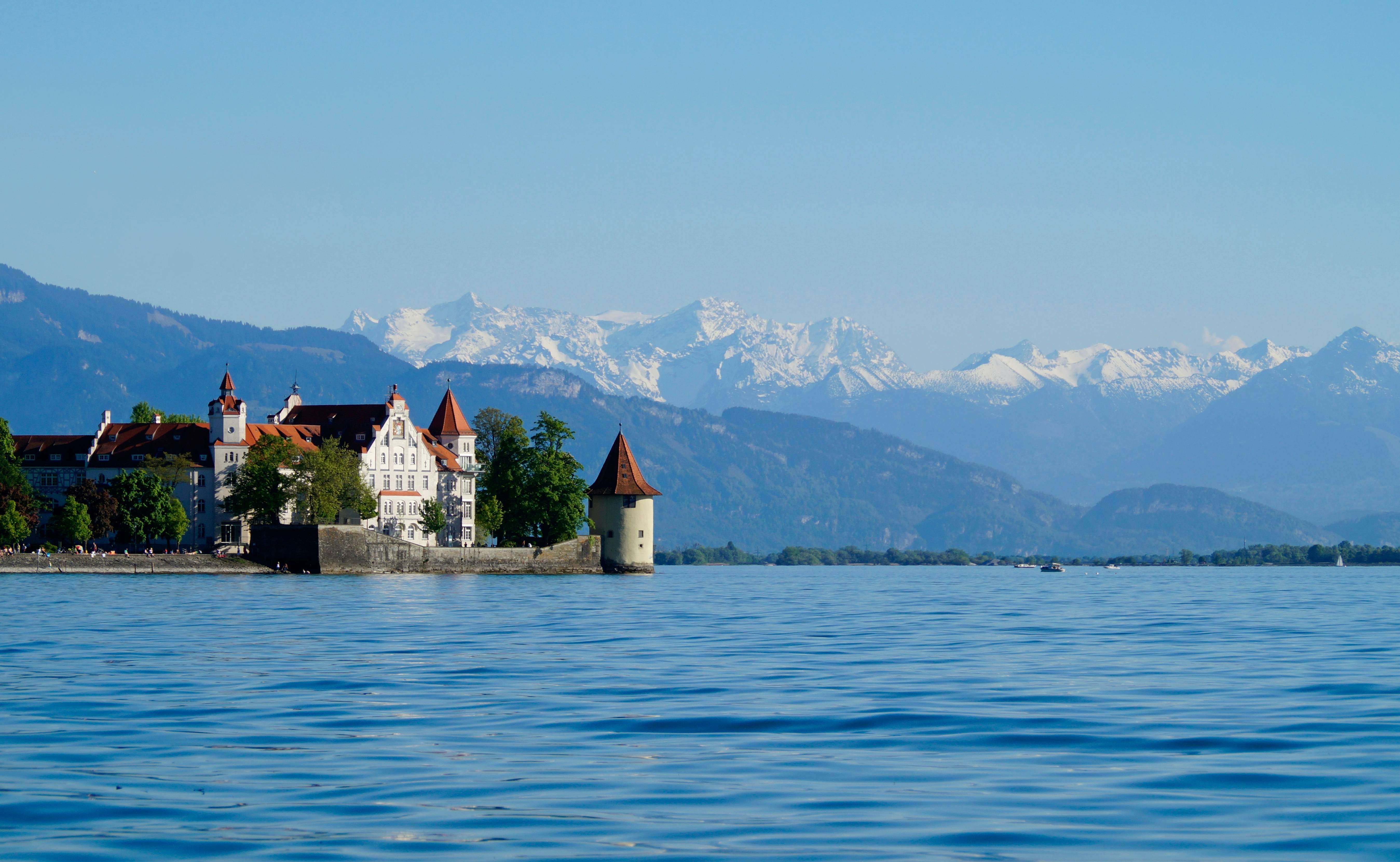 beautiful island of Lindau on lake Constance (lake Bodensee) with the snowy Swiss Alps in the background, Germany on fine sunny spring day                                 License Type: media  Download Time: 2023-12-31T15:56:40.000Z  User: Norma.PrauseBrewer_LonelyPlanet  Is Editorial: No  purchase_order: 56530  
