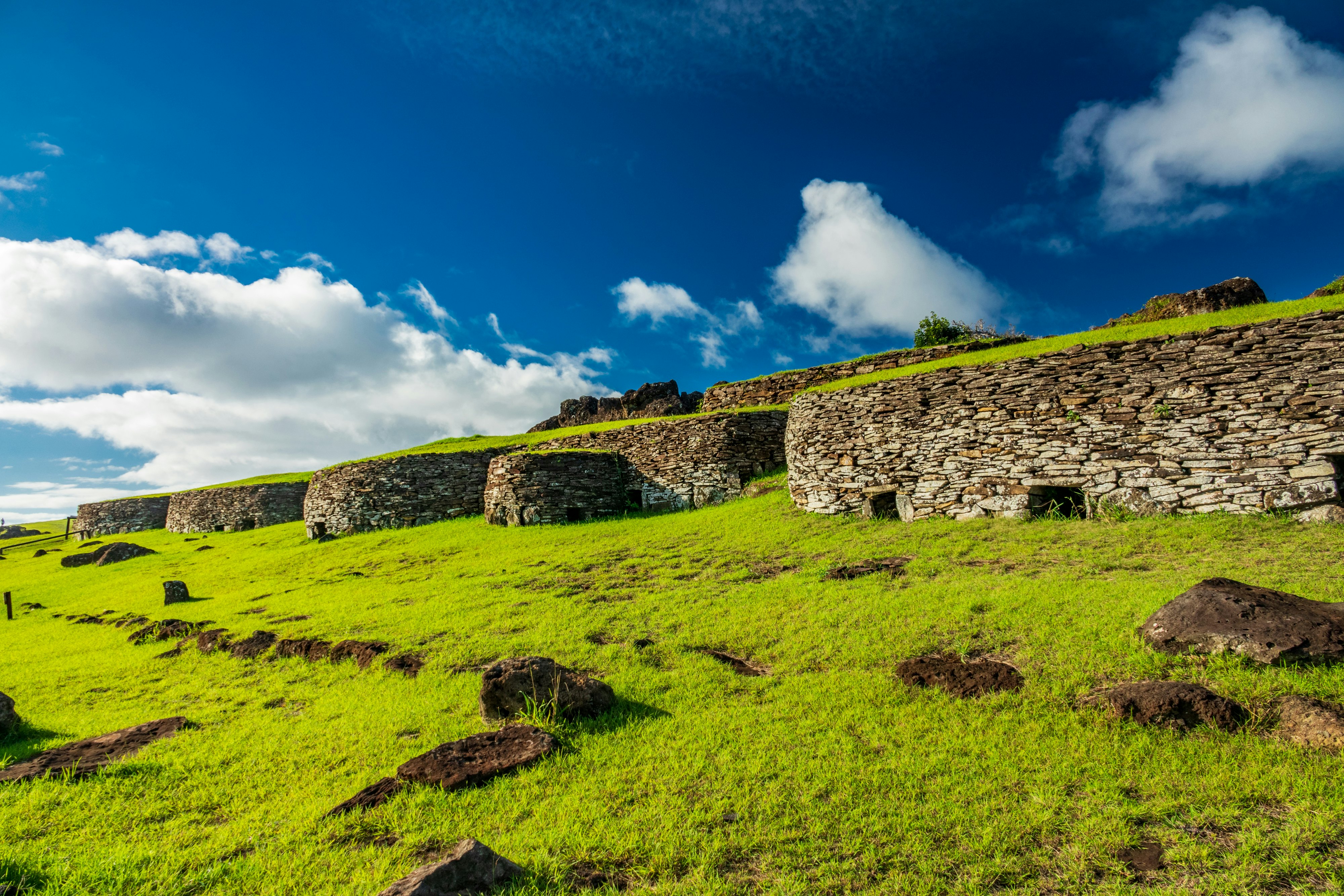 Traditional stone huts under a blue sky at Orongo, Rapa Nui (Easter Island), Chile.
