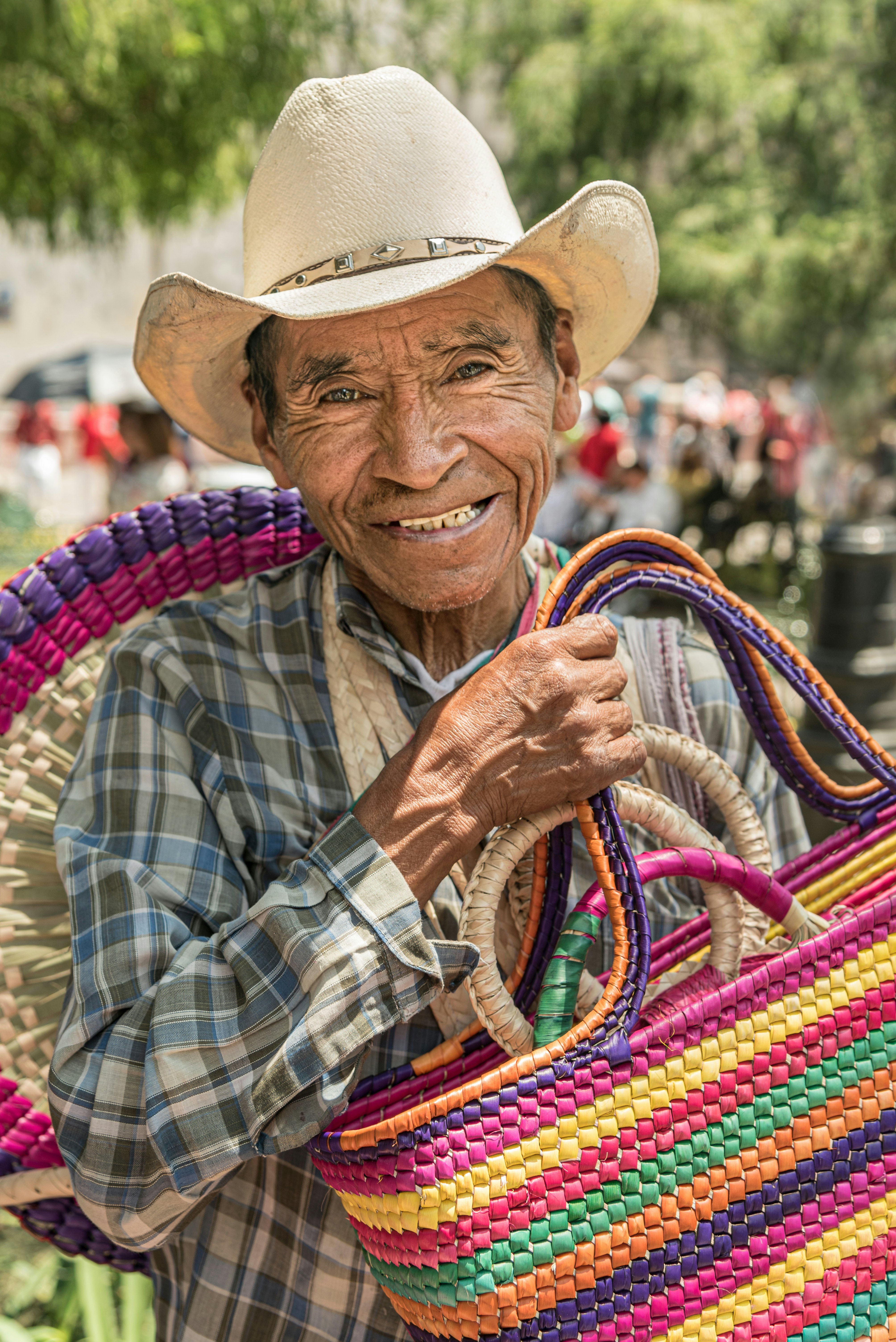 Mexican man selling bags. An old man working as a handmade bag vendor in Mexico.