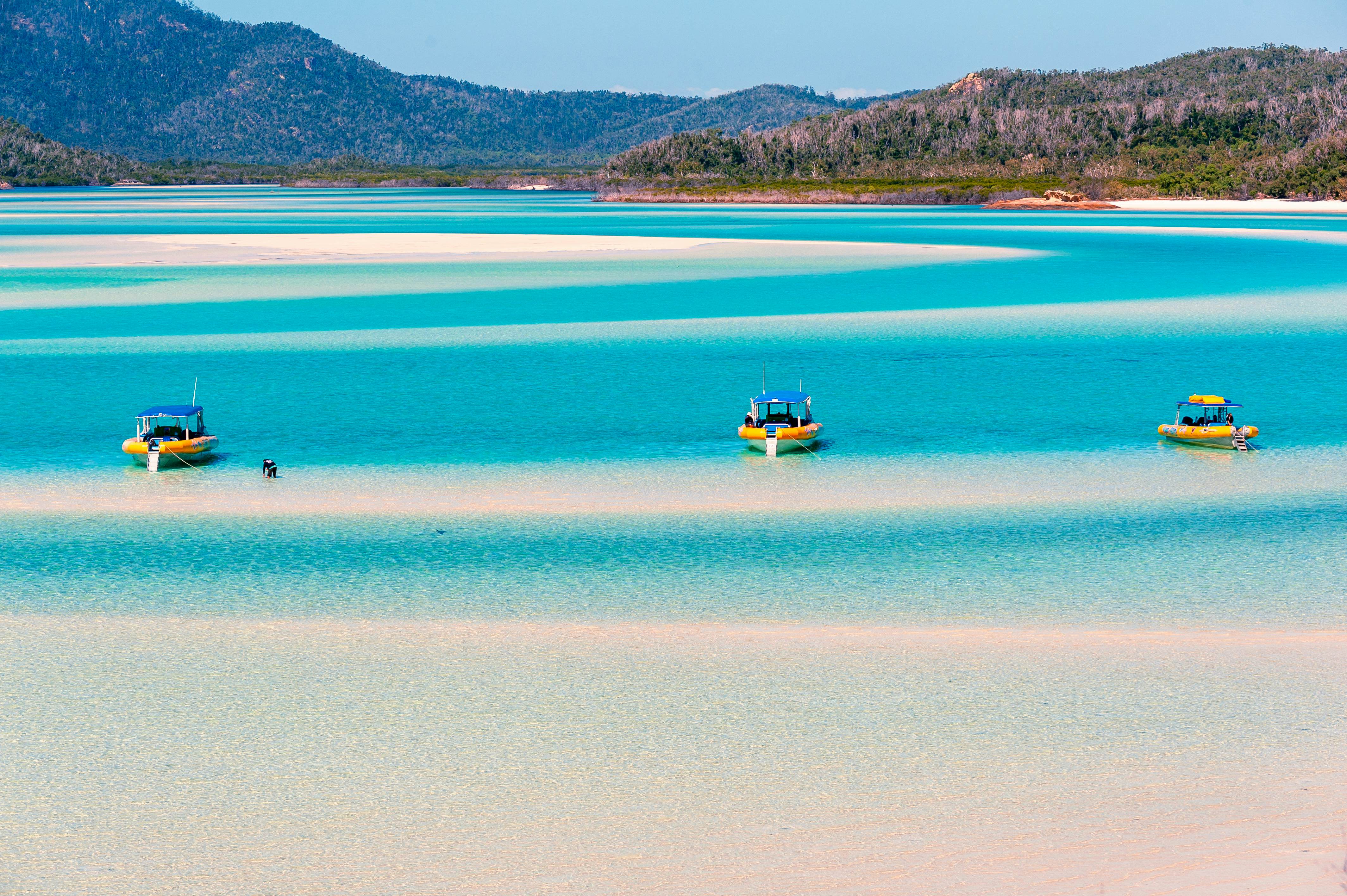 Hill Inlet, Whitsunday Island, Queensland, Australia - Jul 23, 2018: Inflatable yellow dive boats moored on the sandbanks in clear blue water at Hill Inlet under a clear sky. Patterns in the white sand., License Type: media, Download Time: 2026-01-13T19:04:40.000Z, User: LP_KBaxter, Editorial: false, purchase_order: 65050 - Digital Destinations and Articles, job: lonely planet, client: A guide to the Whitsundays in Australia, other: Kathleen Baxter