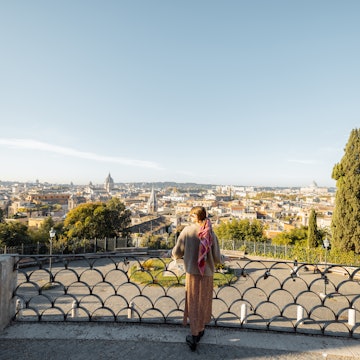 Woman enjoying beautiful morning cityscape of Rome, walking in Villa Borghese Park. Old fashioned woman wearing coat with colorful shawl in hair. Concept of italian lifestyle and travel, License Type: media, Download Time: 2026-01-09T16:48:43.000Z, User: rhylton_redventures, Editorial: false, purchase_order: 65050 - Digital Destinations and Articles, job: Lonely Planet, client: wip, other: Rhianydd Hylton
