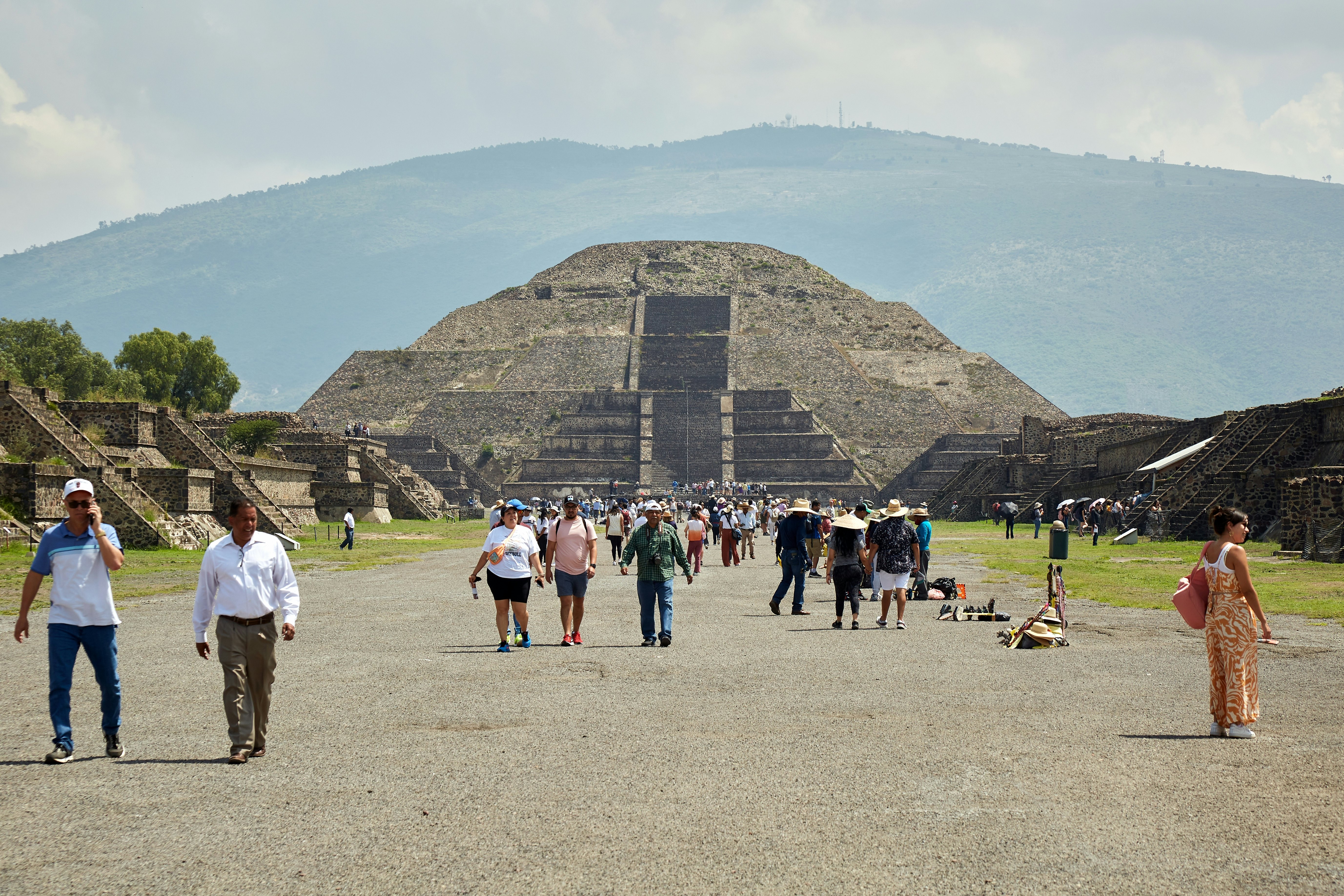 People walking the Calzada de los Muertos (Avenue of the Dead) at Teotihuacán in Mexico.