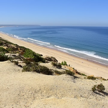 Fonte da Telha Beach in Costa da Caparica coast, with the Espichel Cape seen at the Atlantic Ocean horizon. Portugal; Shutterstock ID 2388653431; purchase_order:65050 - Digital Destinations and Articles; job:LP Digitial; client:Lonely Planet digital destinations; other:Nicole McElroy
2388653431