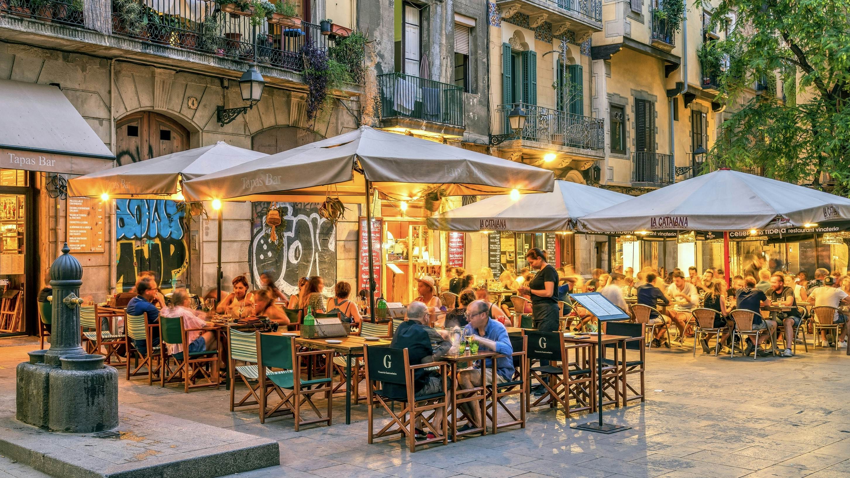 Barcelona, Catalonia, Spain - September 12, 2023: Outdoor tapas restaurant in a small square of Born district
2395767285
alfresco,  bar,  barcelona,  born,  building,  buildings,  cafe,  catalan,  catalonia,  city,  corner,  destination,  district,  espana,  europe,  european,  exterior,  holidays,  mediterranean,  neighborhood,  night,  nightlife,  outdoor,  picturesque,  plaza,  restaurant,  sightseeing,  spain,  spanish,  square,  tapas,  tourists,  travel,  vacation,  al fresco,  city center,  old town,  southern europe,  tourist attraction,  western europe,  Cafe,  Cafeteria,  Chair,  City,  Furniture,  Indoors,  Lamp,  Neighborhood,  Path,  Person,  Plant,  Restaurant,  Road,  Shoe,  Street,  Urban
Barcelona, Catalonia, Spain - September 12, 2023: Outdoor tapas restaurant in a small square of Born district