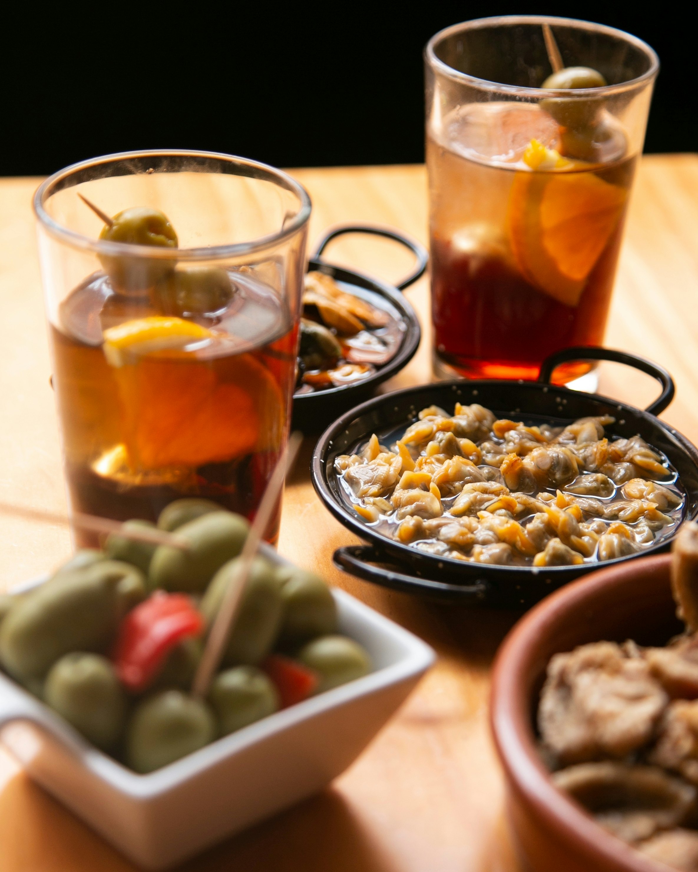 Table with Spanish tapas and vermouth at noon in a bar in Barcelona.