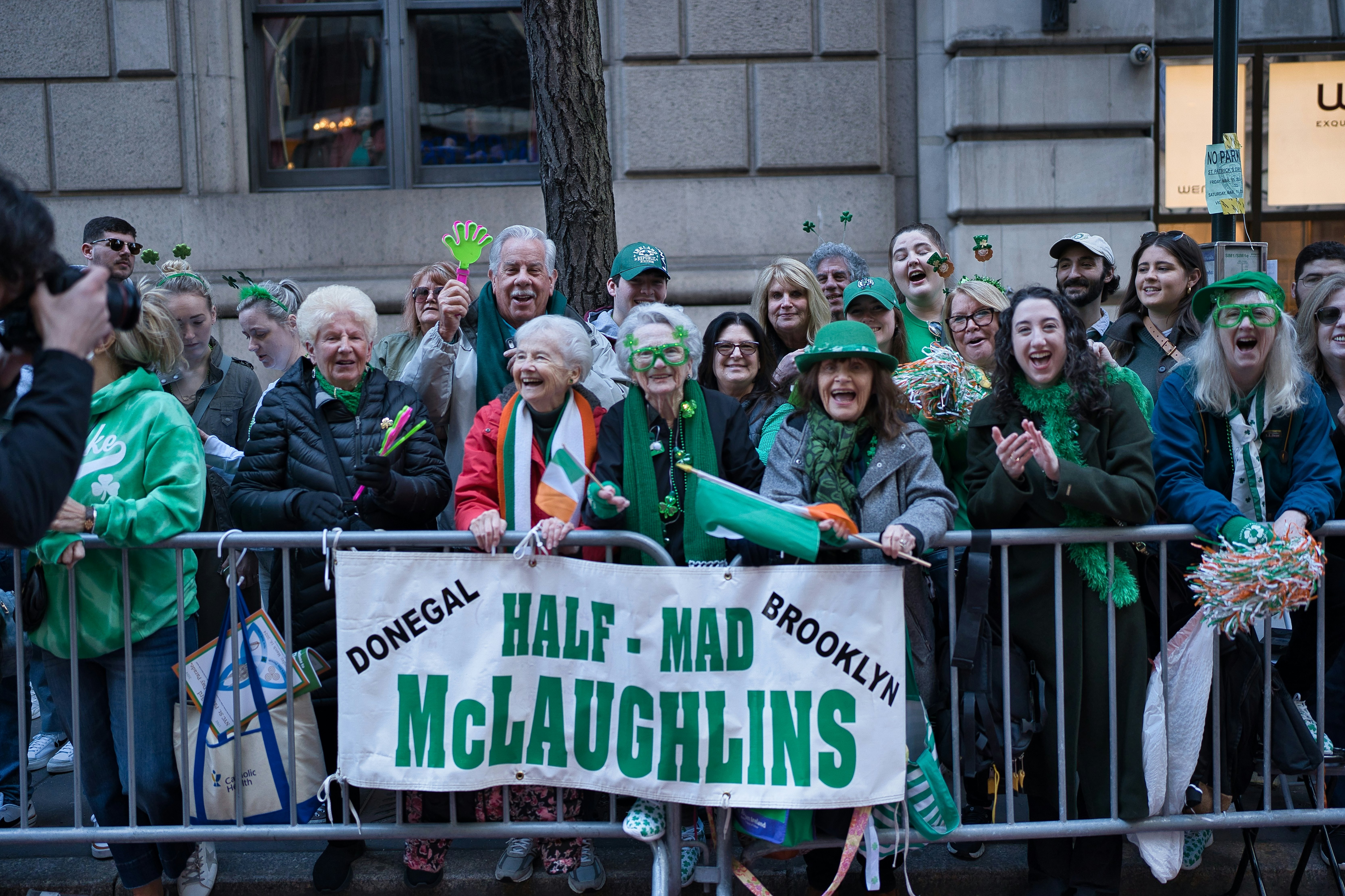Spectators and participants crowd Fifth Avenue for the St. Patrick's Day Parade, celebrating Irish culture with music, dance, and vibrant displays of green.