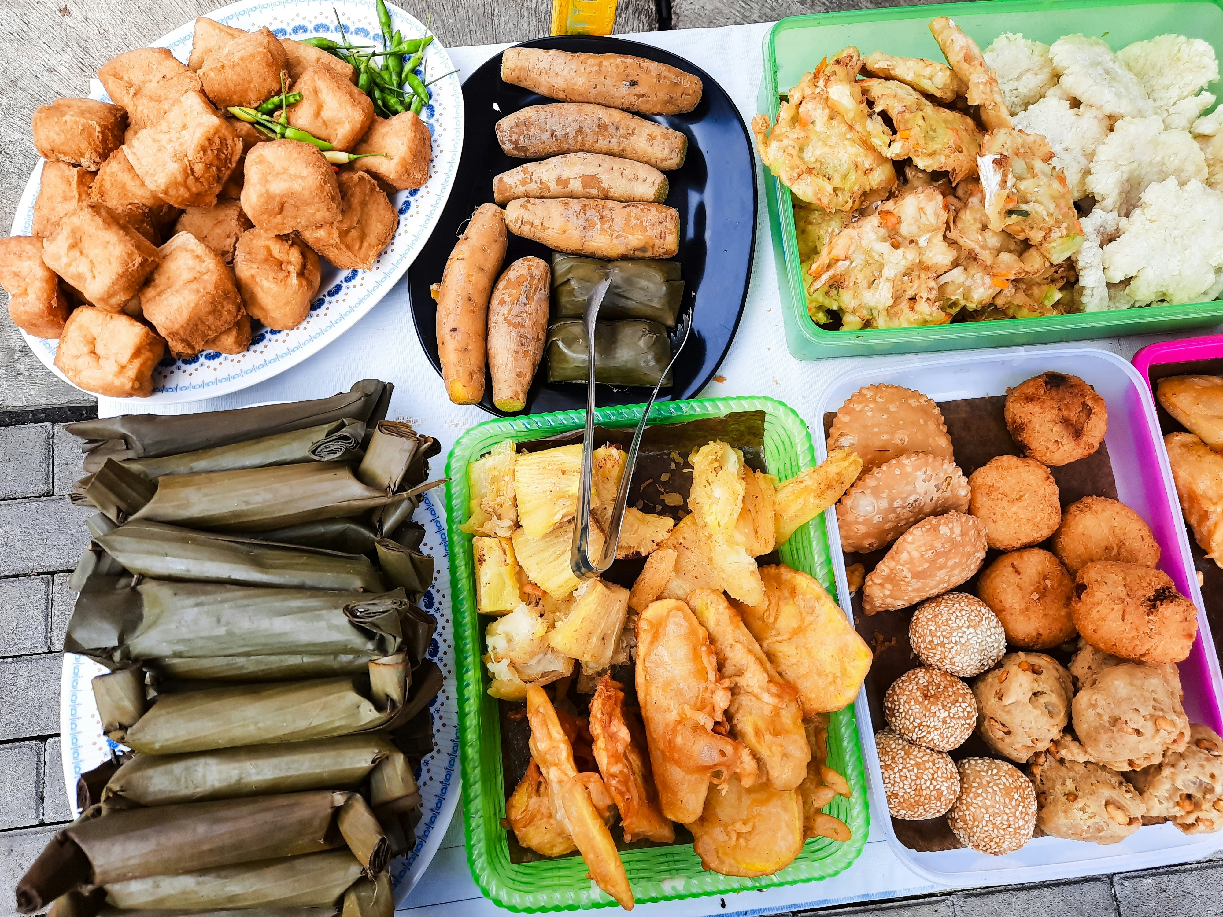 Containers of fried and wrapped foods.