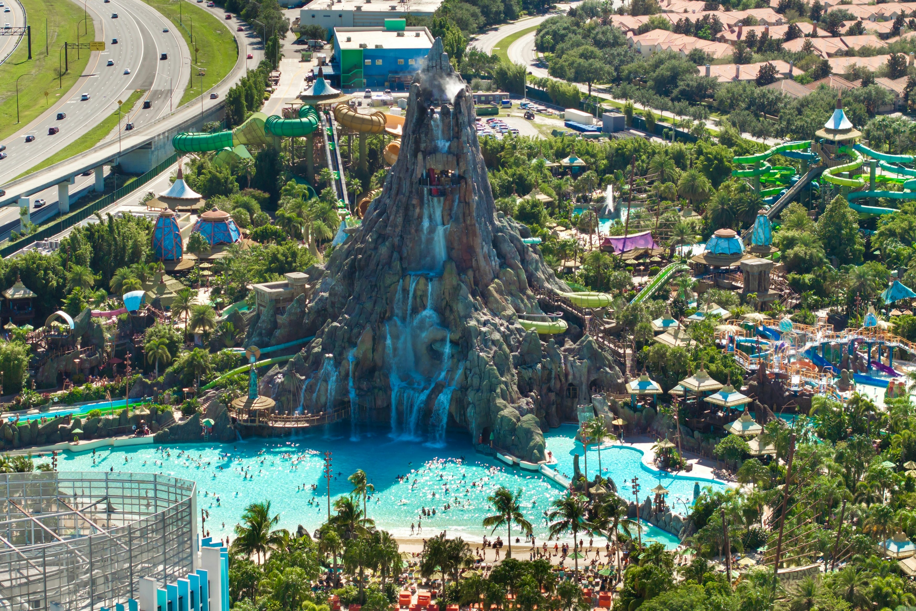 A vast artifical volcano-like structure forming a waterfall feature at a water park.