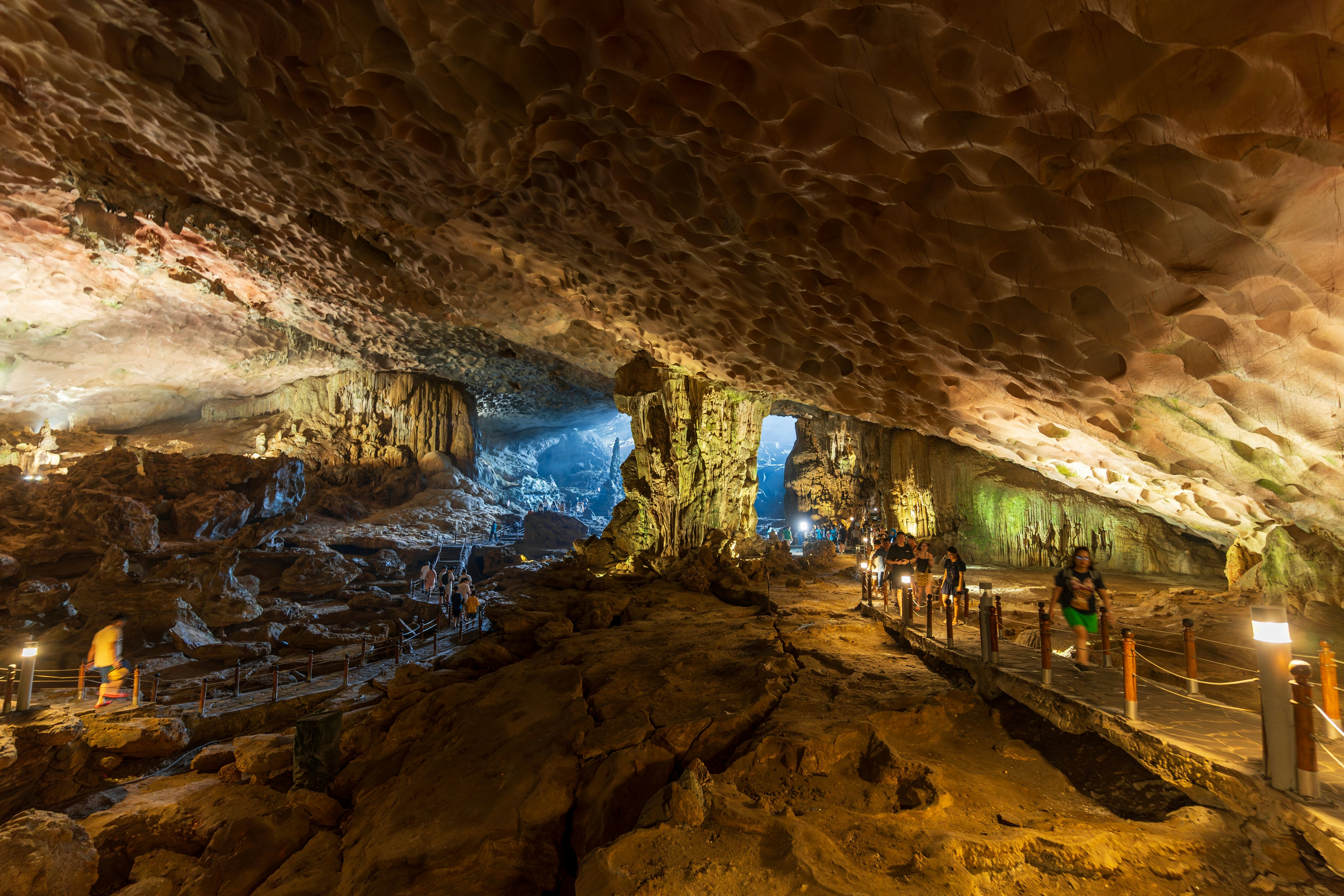 Visitors walk on platforms through a cave in Vietnam.