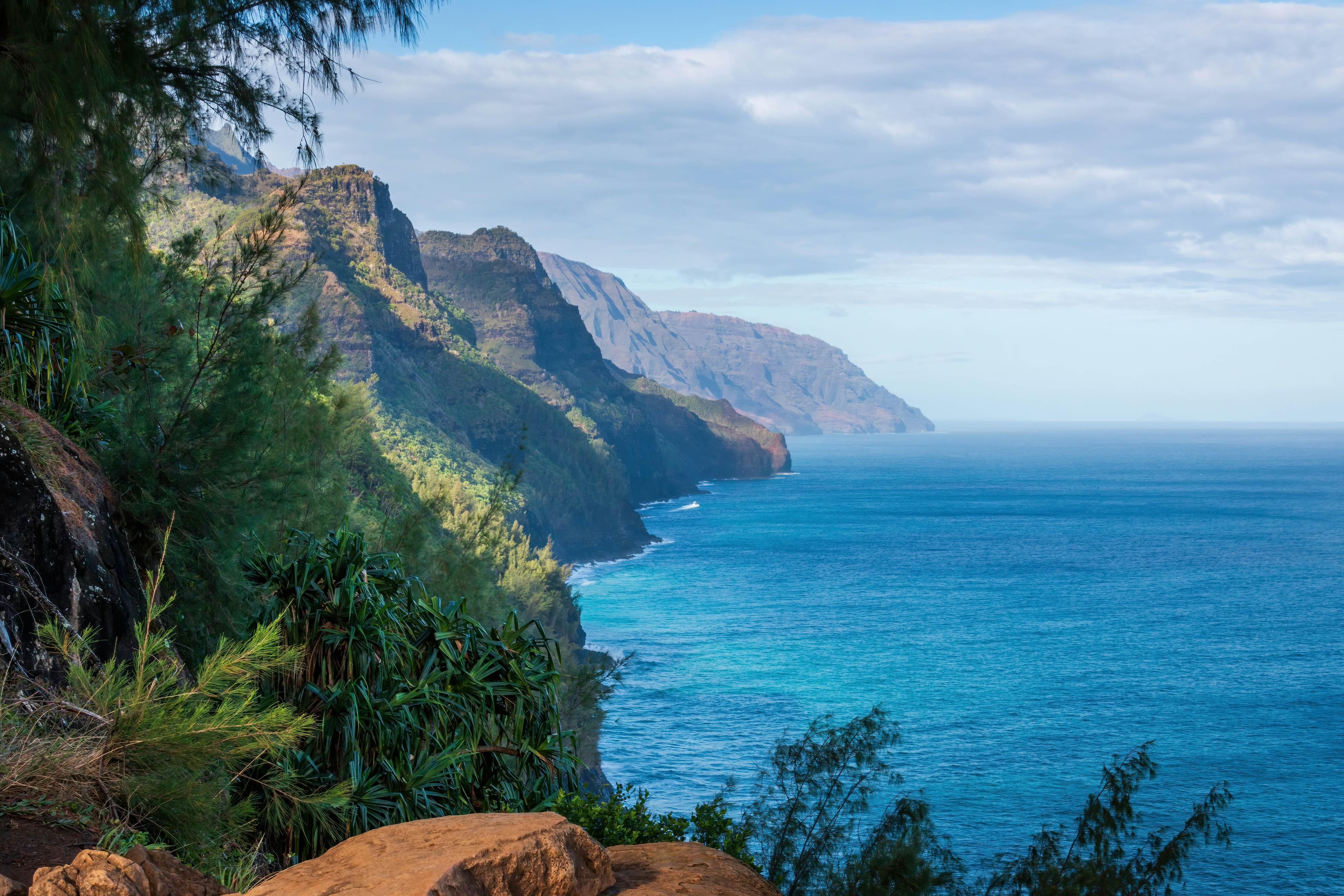 Scenic view of amazing Napali Coast seen from Kalalau Trail, Kauai, Hawaii, USA against blue sky with clouds in the morning; Shutterstock ID 2521379375; purchase_order:65050 - Digital Destinations and Articles; job:Online editorial; client:Epic hikes of the Americas article refresh; other:Ann Douglas Lott
2521379375