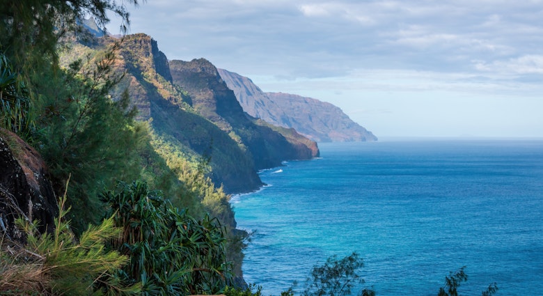 Scenic view of amazing Napali Coast seen from Kalalau Trail, Kauai, Hawaii, USA against blue sky with clouds in the morning; Shutterstock ID 2521379375; purchase_order:65050 - Digital Destinations and Articles; job:Online editorial; client:Epic hikes of the Americas article refresh; other:Ann Douglas Lott
2521379375