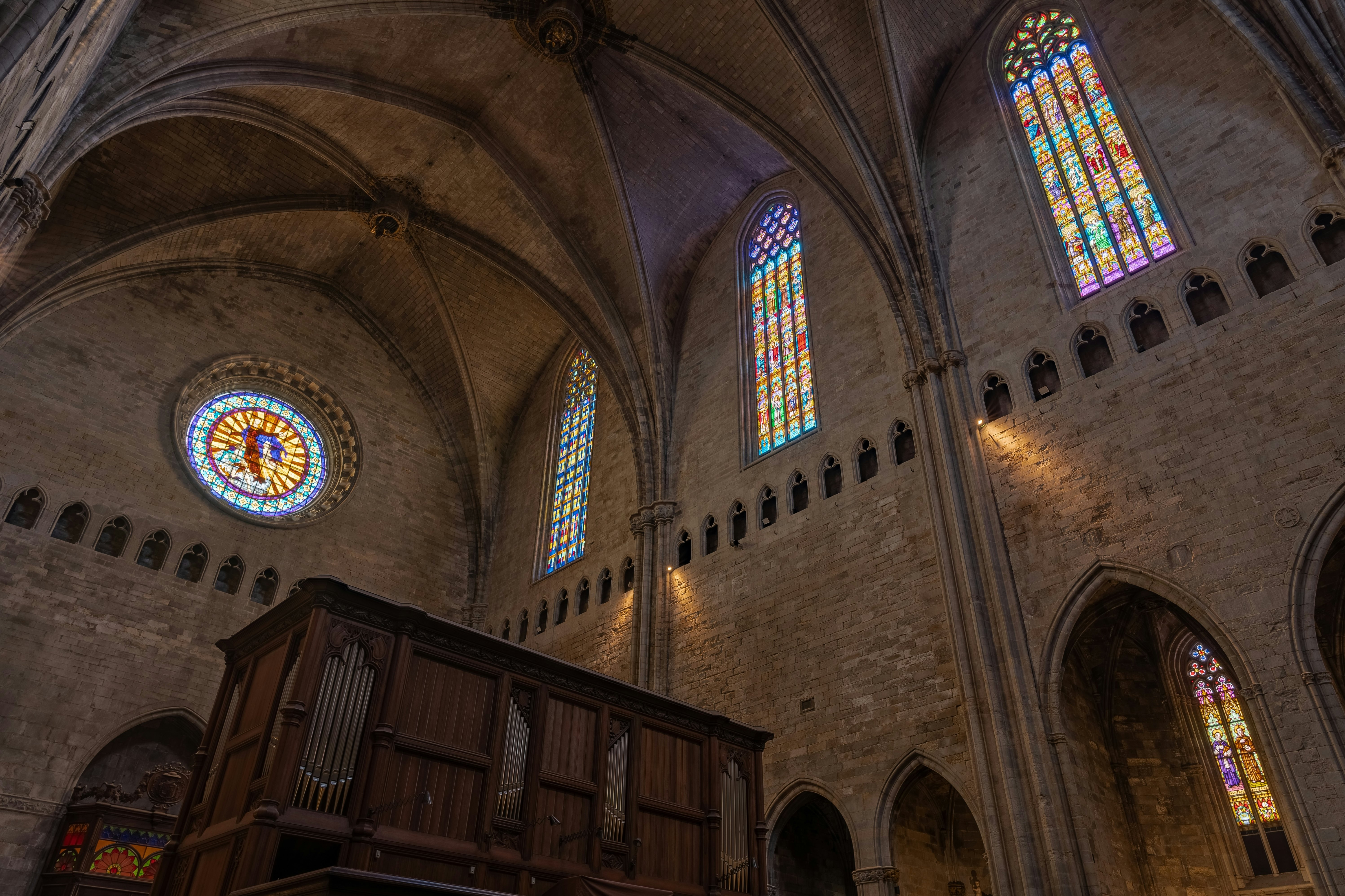 Interior of a church with long, narrow stained glass windows