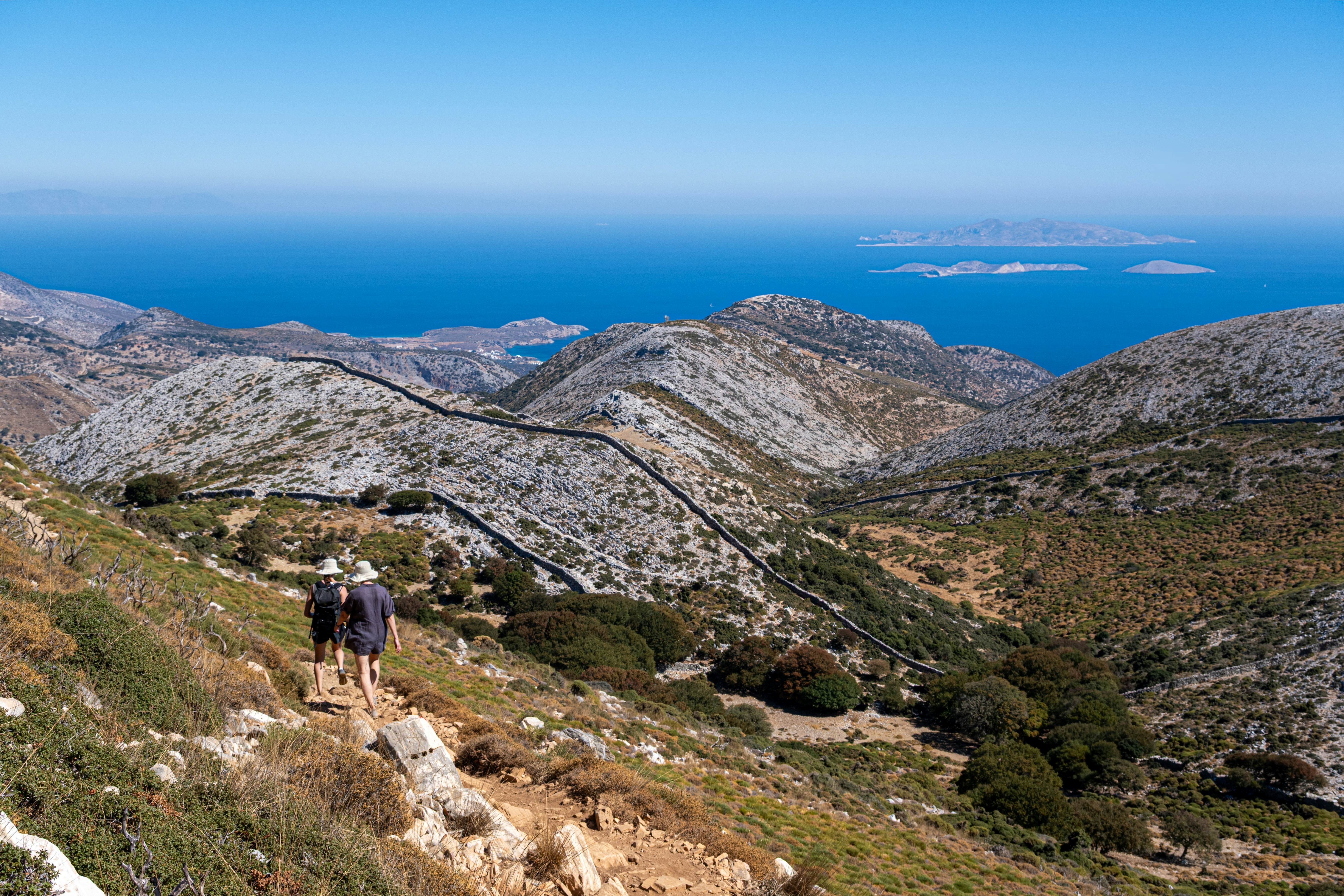 Naxos, Greece - 2 October 2024: Two hikers walking down a trail on Mount Zeus, the highest peak in the Cyclades, License Type: media, Download Time: 2026-01-14T17:32:41.000Z, User: joebindloss38, Editorial: true, purchase_order: 65050 - Digital Destinations and Articles, job: Online editorial, client:  Hiking Greece – the top trails, from Crete to the Peloponnese, other: Joe Bindloss