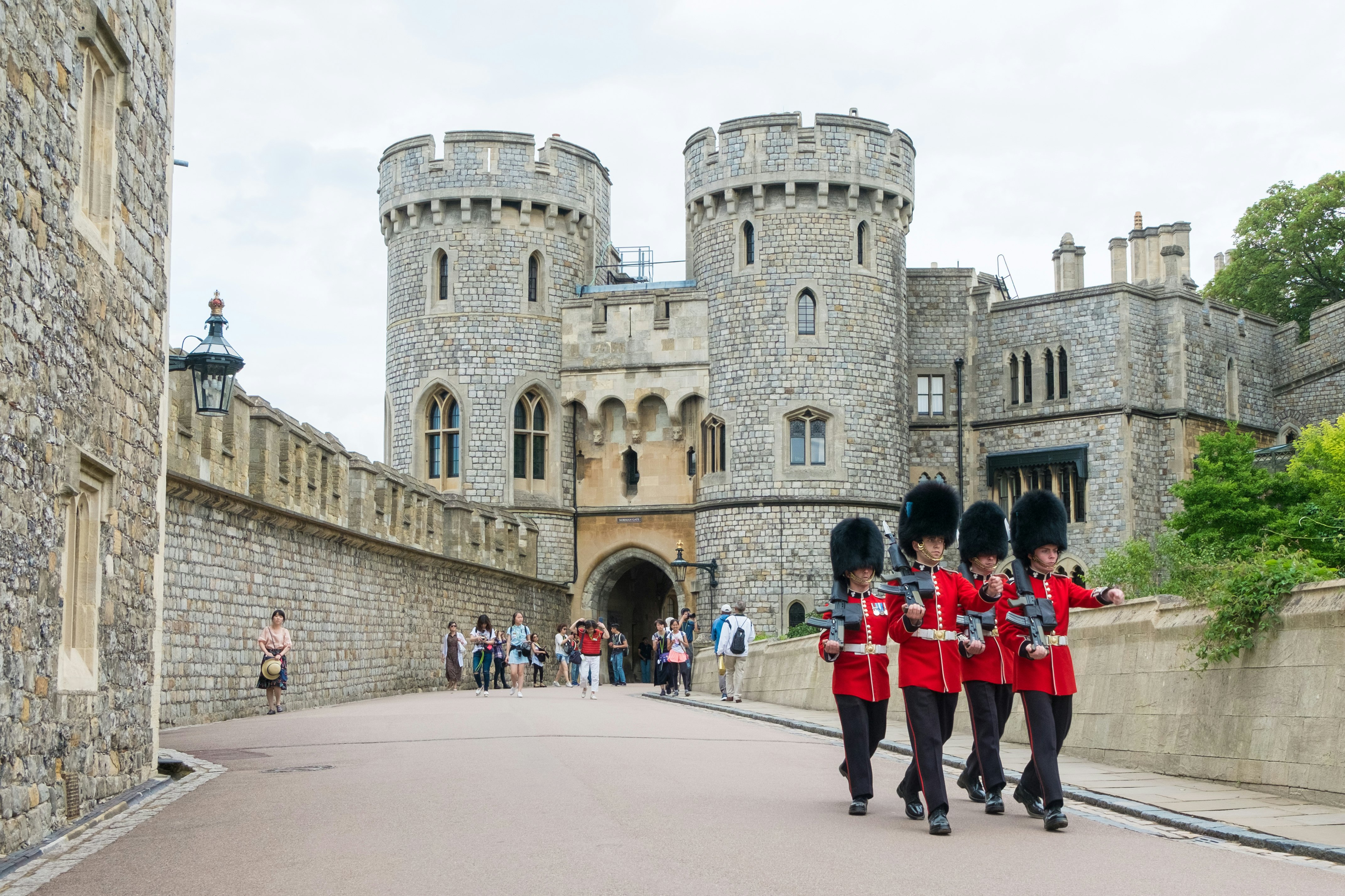Windsor guard in red uniform walking around Windsor castle, Berkshire, United Kingdom