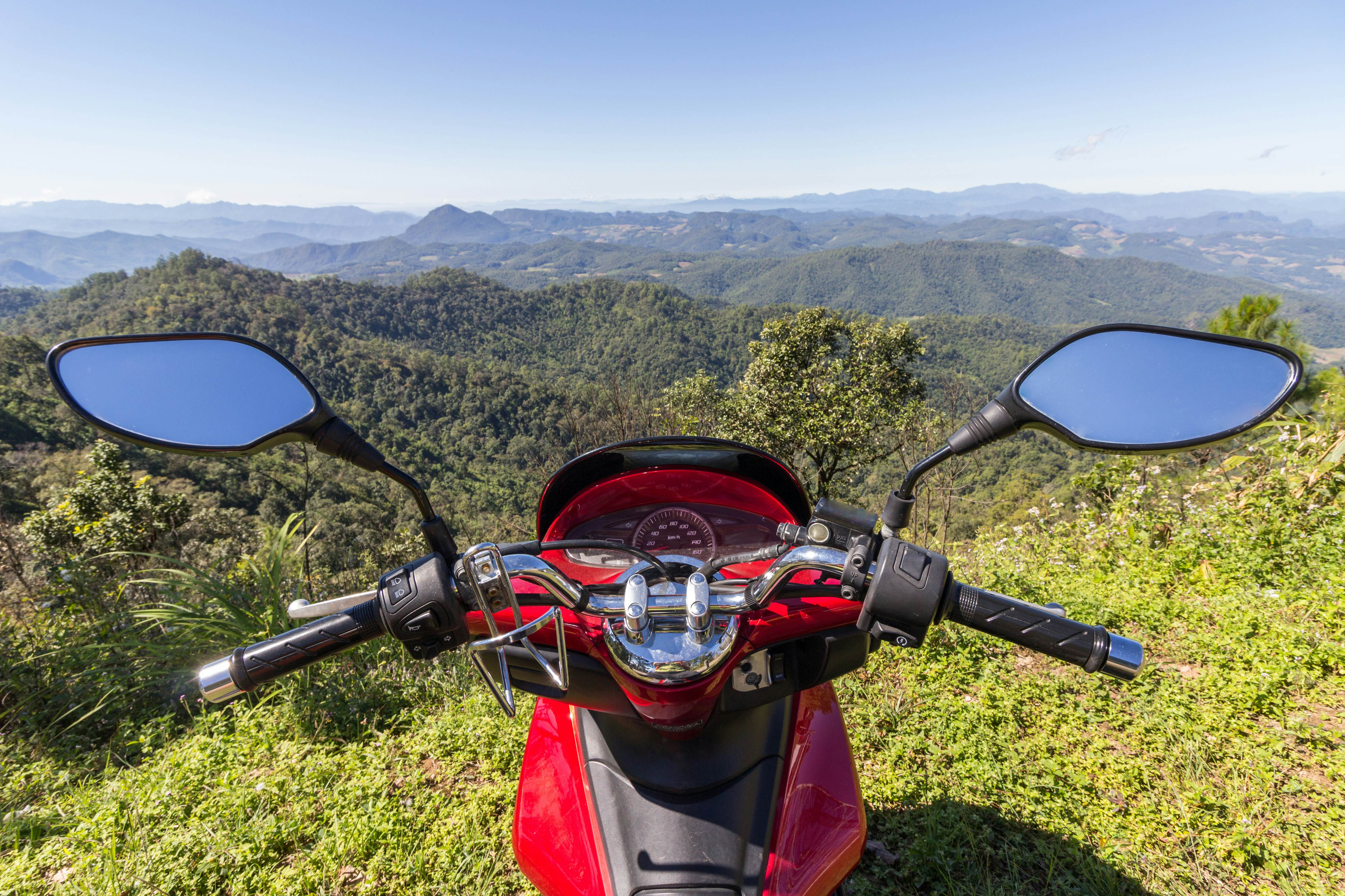 Red motorbike on the edge of a hill and green mountains in sunny day in Thailand; Shutterstock ID 538299268; purchase_order:65050 - Digital Destinations and Articles; job:Digital editorial ; client:How riding a motorbike in Southeast Asia set me free; other:Acacia Gabriel
538299268