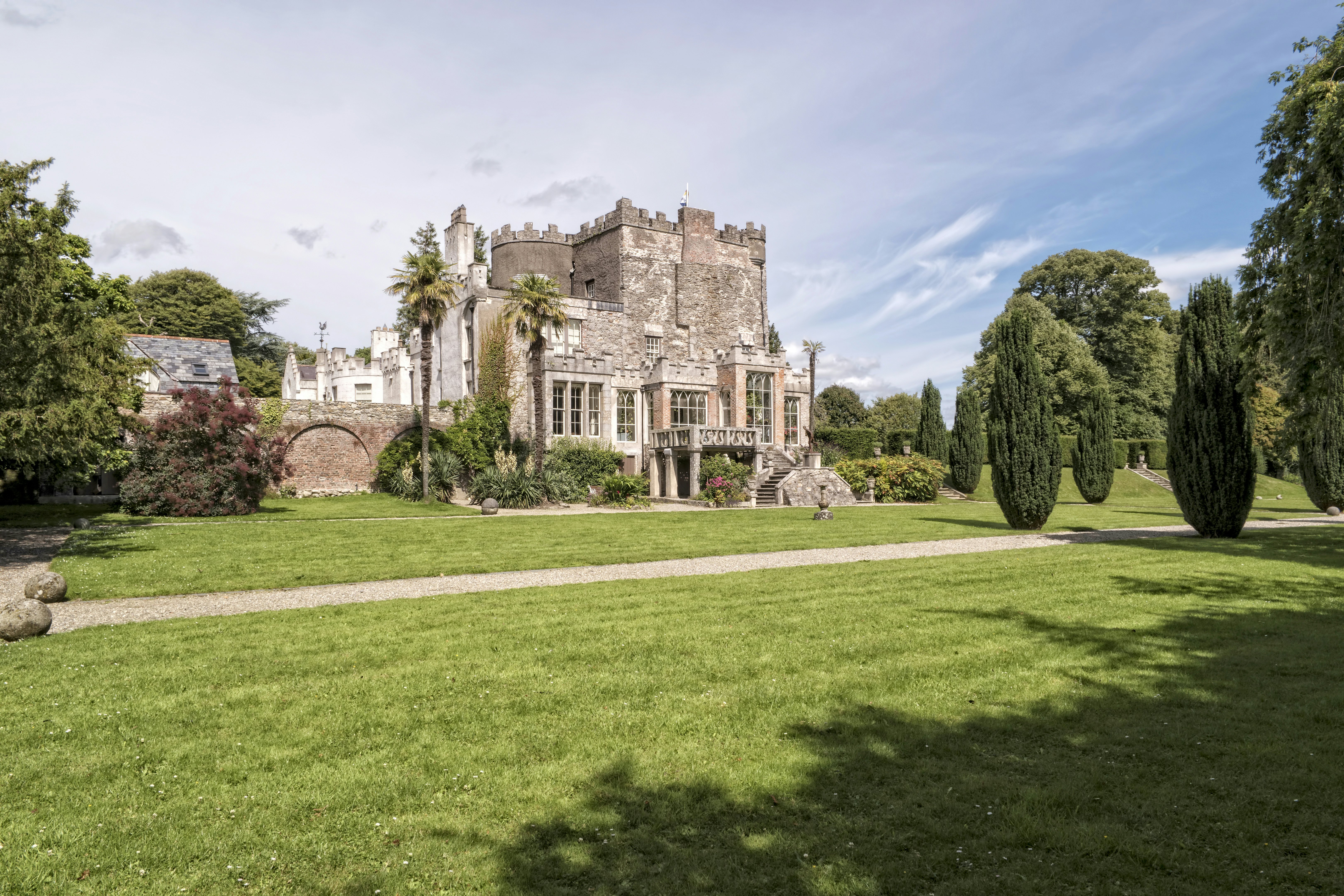An ornate castle amid meticulously manicured, green grounds