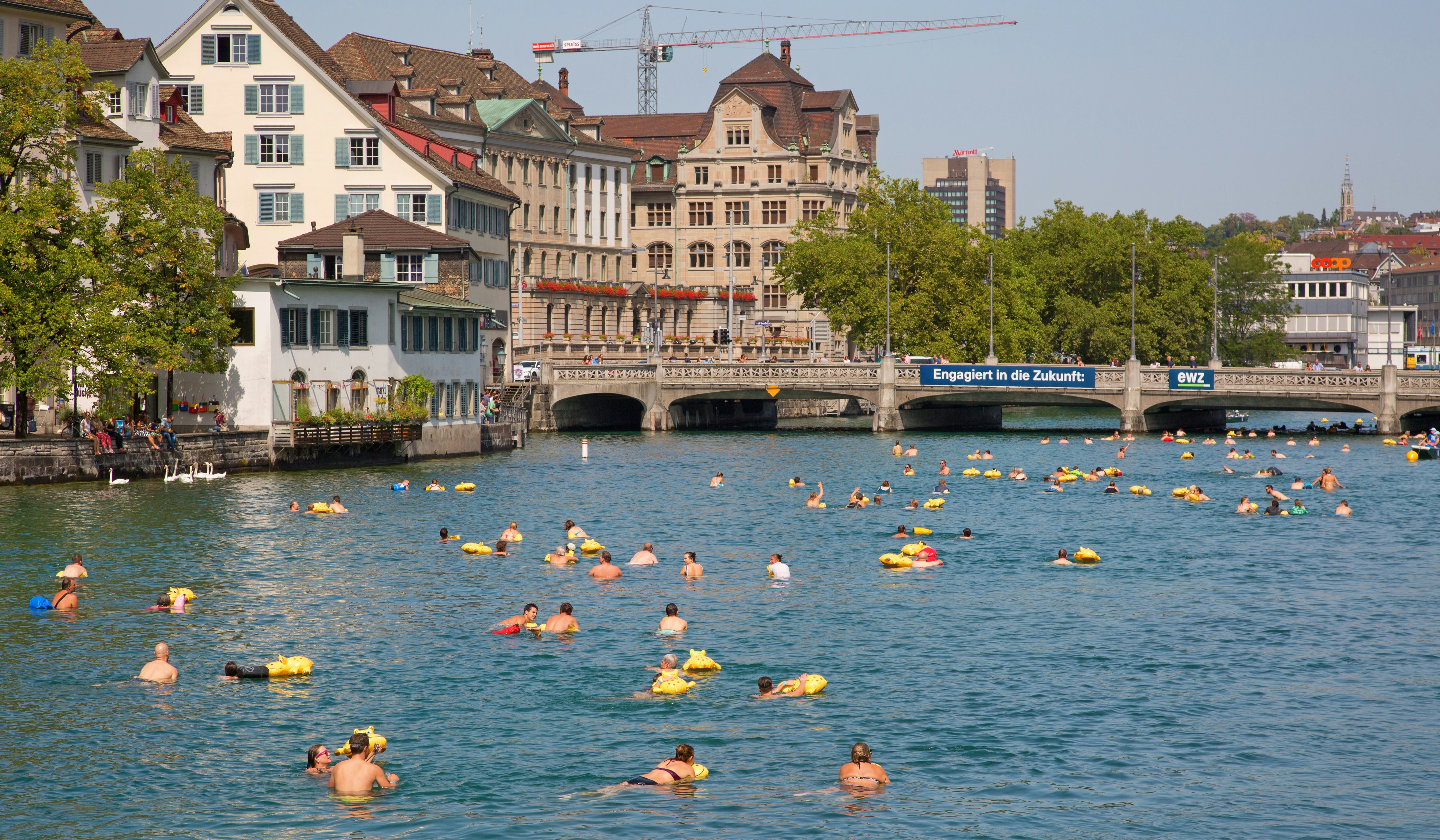 Zurich residents swimming in the Limmat River in the center of Zurich, Switzerland.