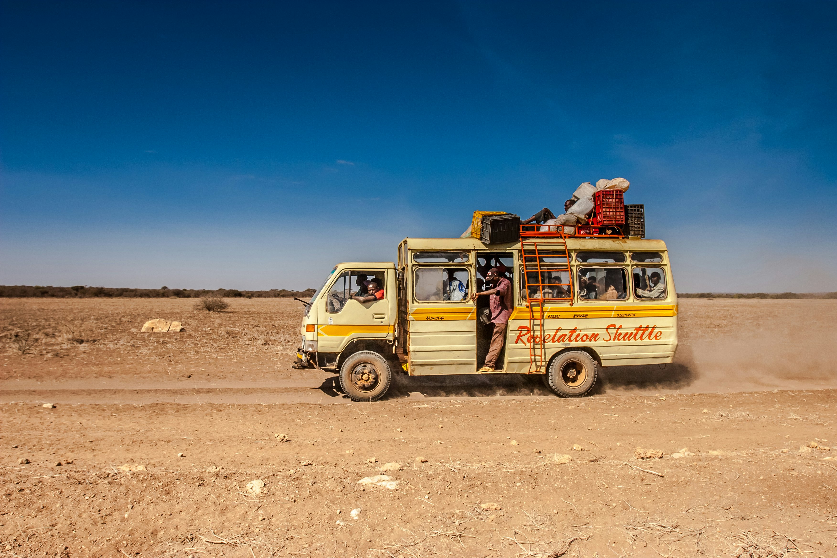 A rural bus on a dirt road in Kenya.
