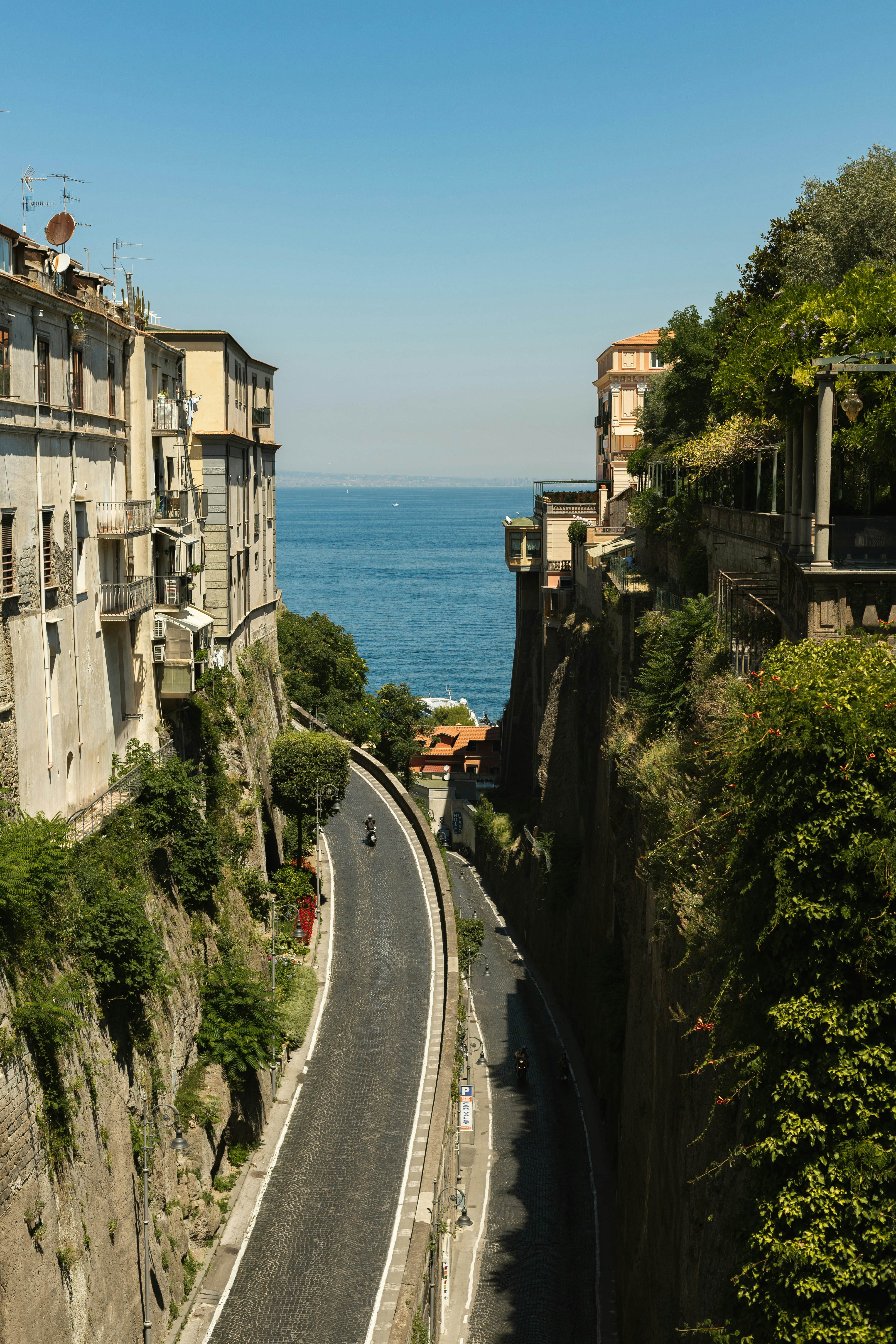 A road between cliffs in a seaside town.