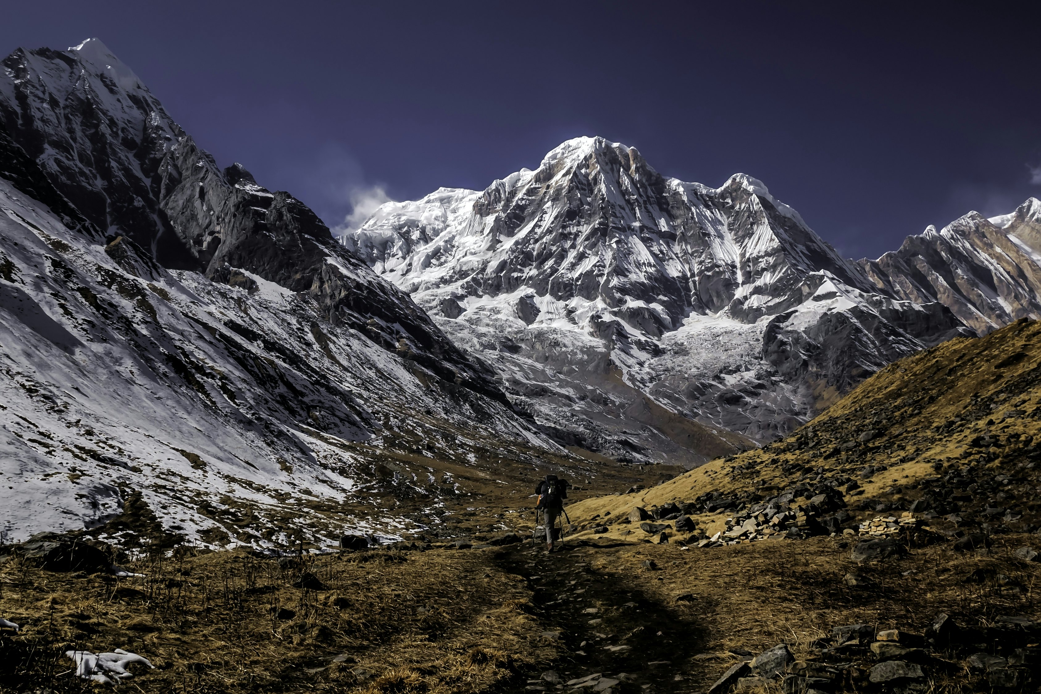 A trekking surrounded by snowpeaks on the trail to the Annapurna Sanctuary, Nepal.