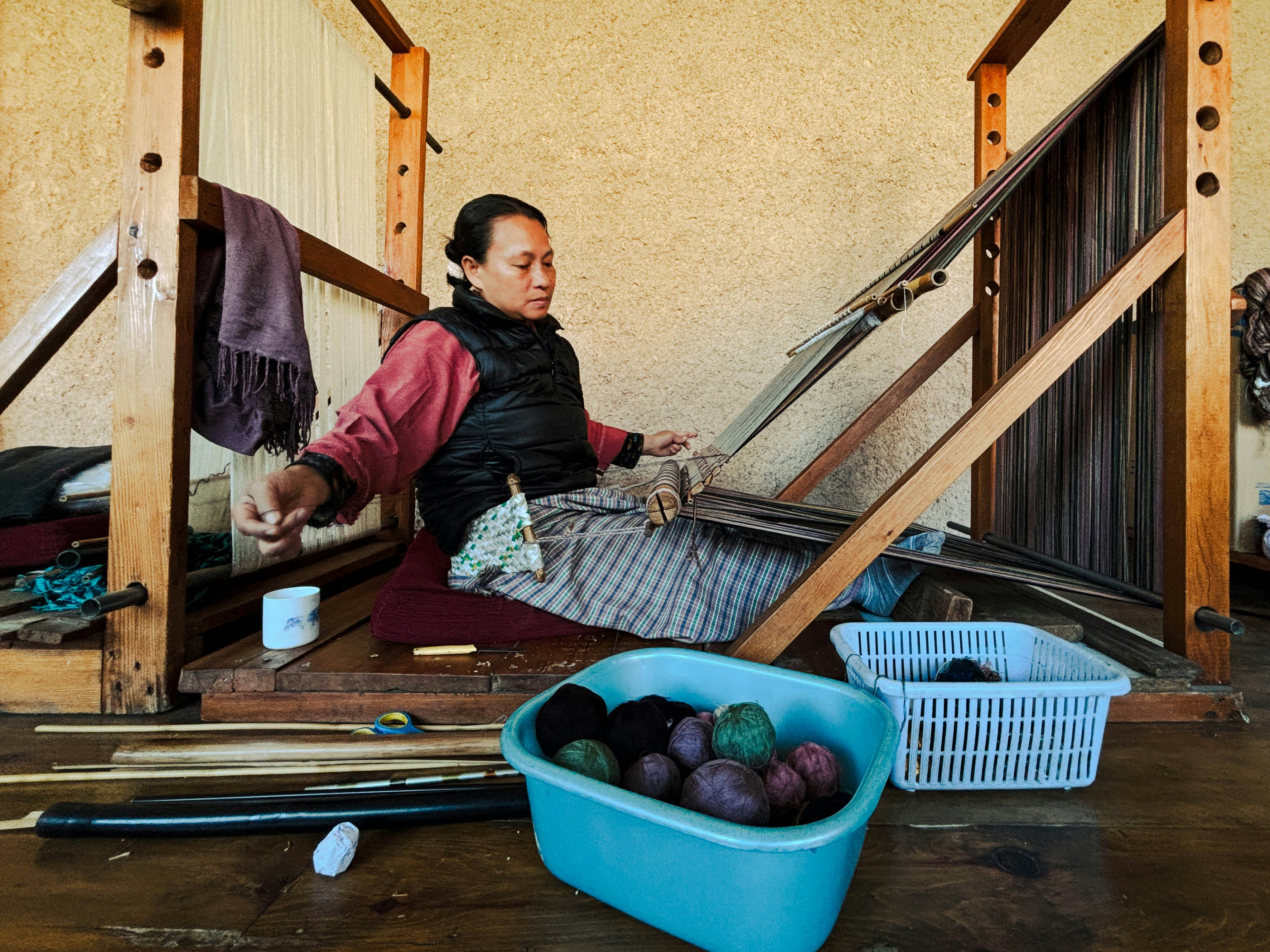 A woman weaving at the Gagyel Lhundrup Weaving Centre in Thimphu, Bhutan.