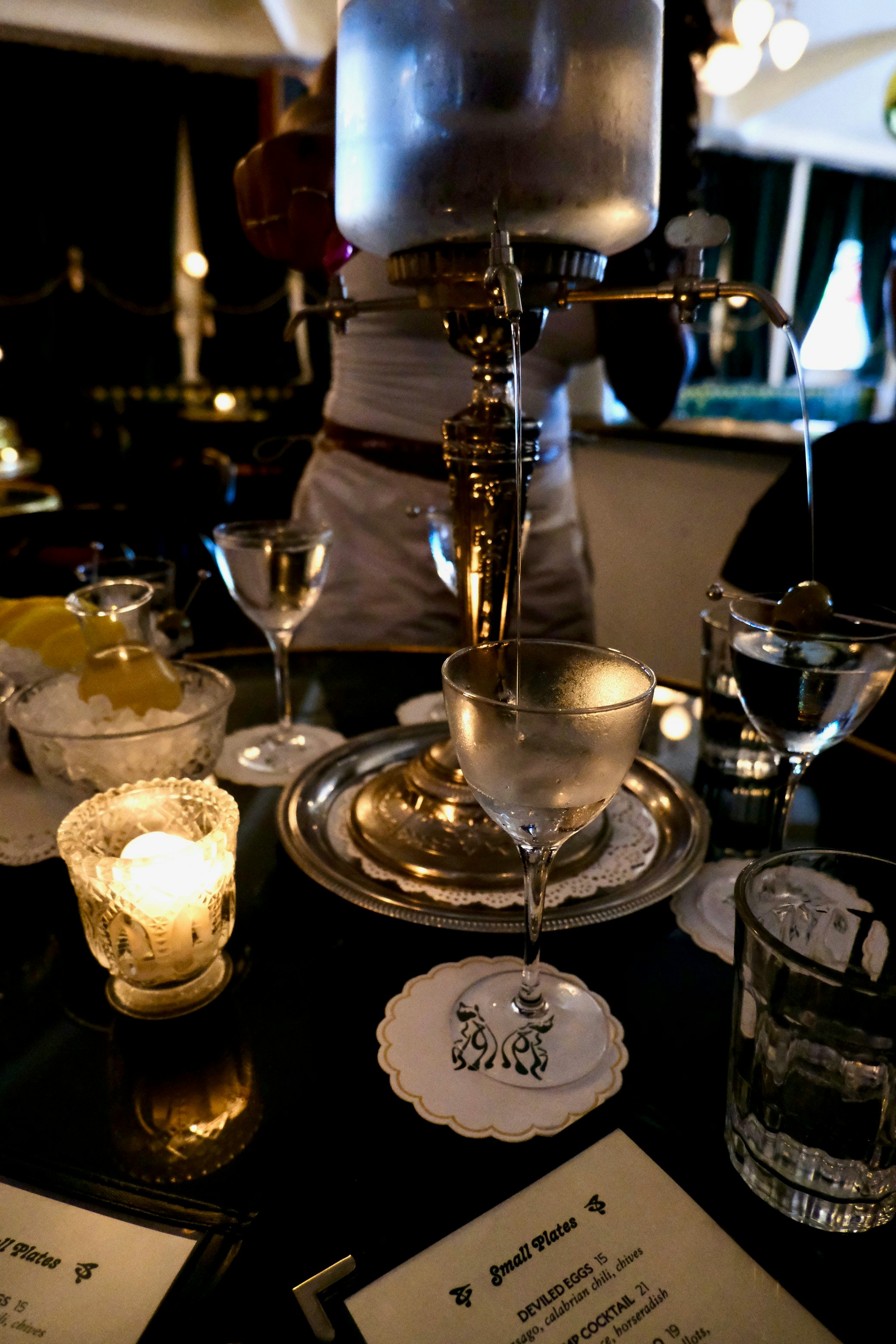 A tabletop fountain pours drinks into clear flutes