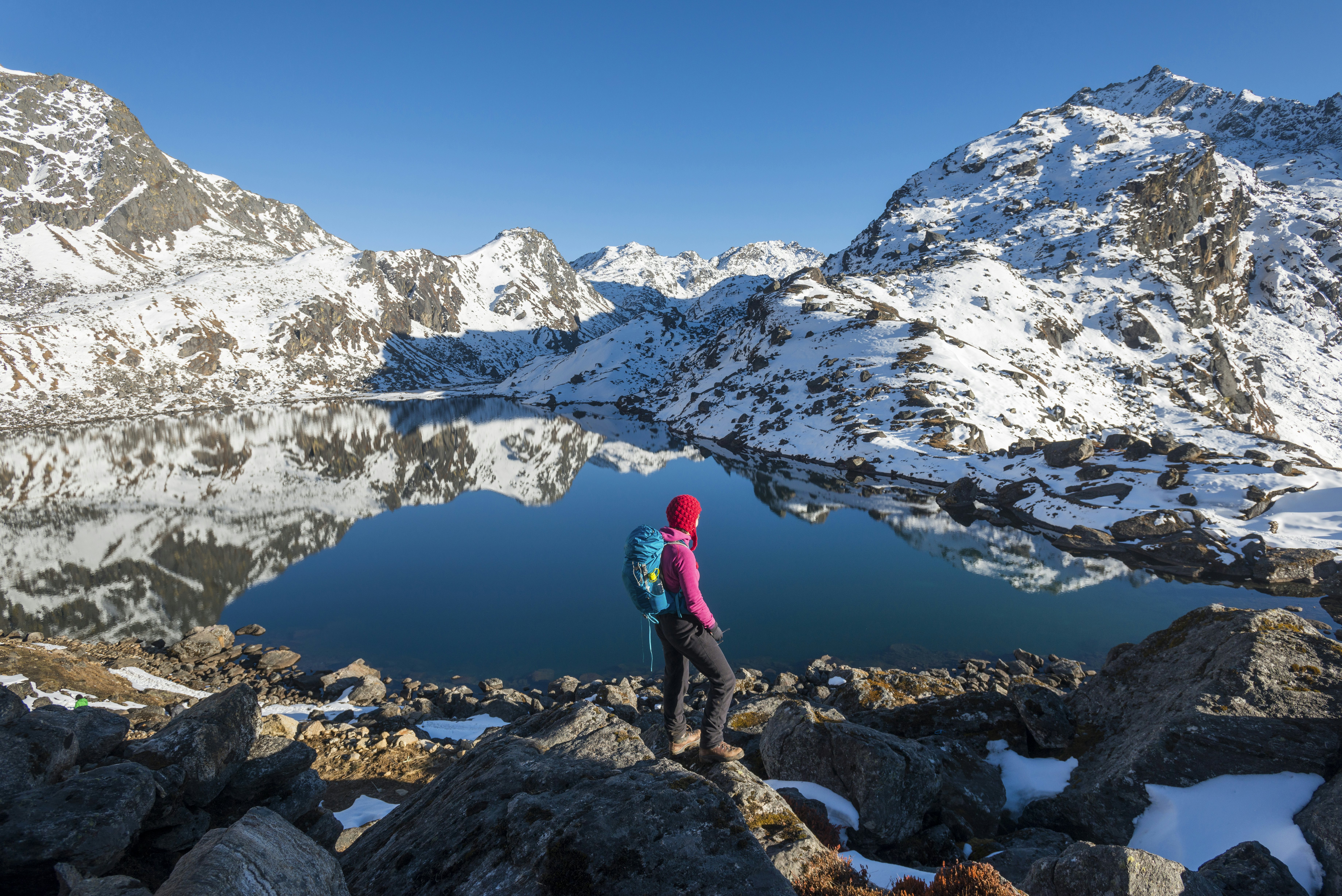 A woman looks out over the holy lake of Gosainkunda in the Langtang region of Nepal.