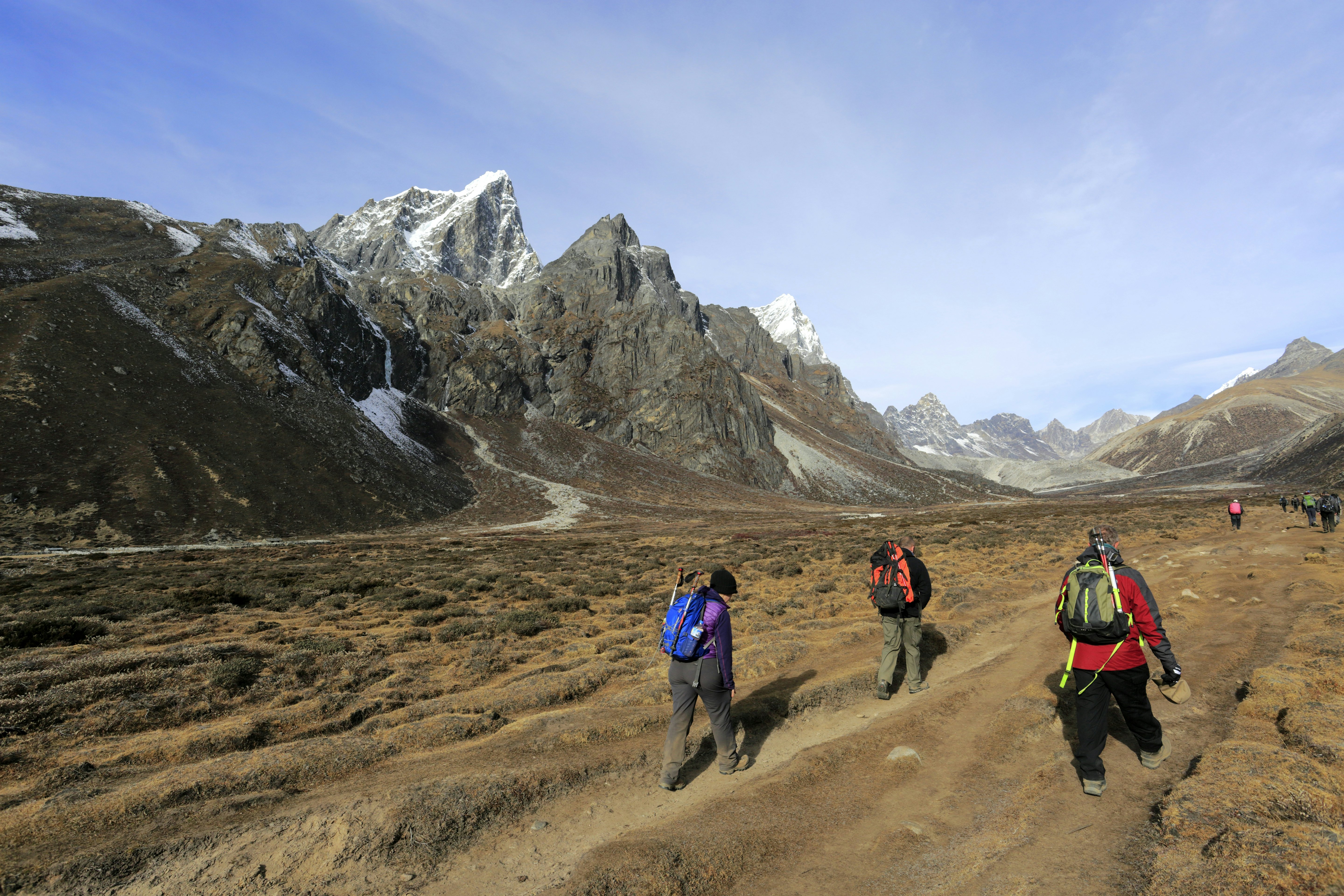 Trekkers walking along the wide valley at Pheriche, on the Everest Base Camp trekking route, Nepal.