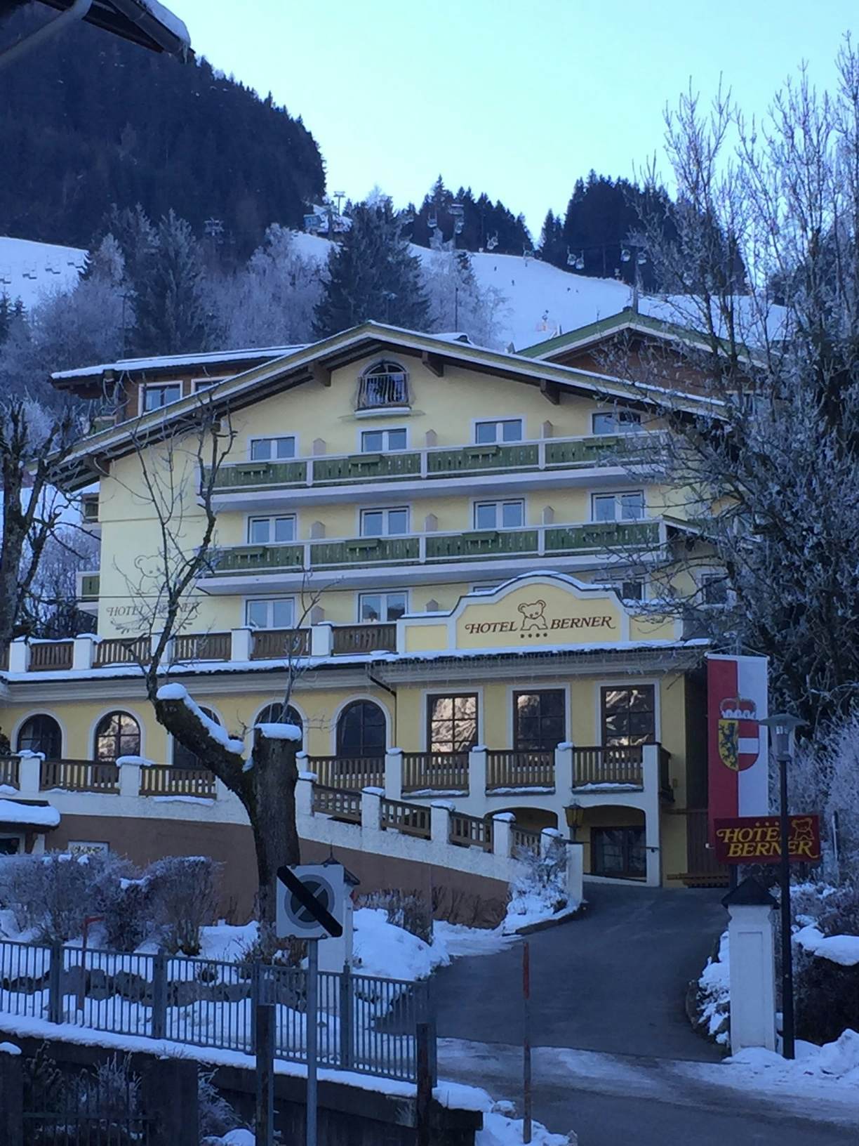 A yellow building with a ramp leading to a porch.