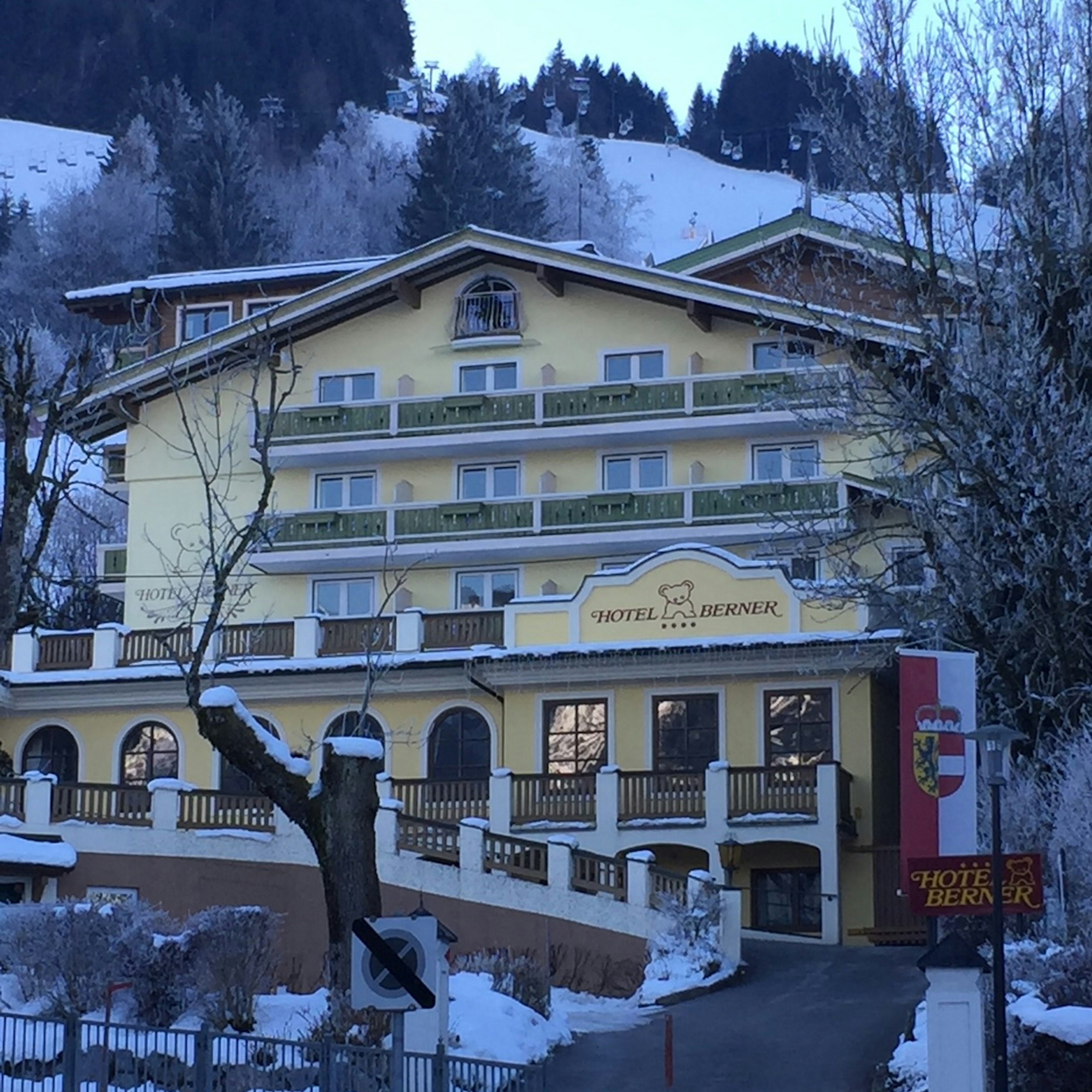 A yellow building with a ramp leading to a porch.