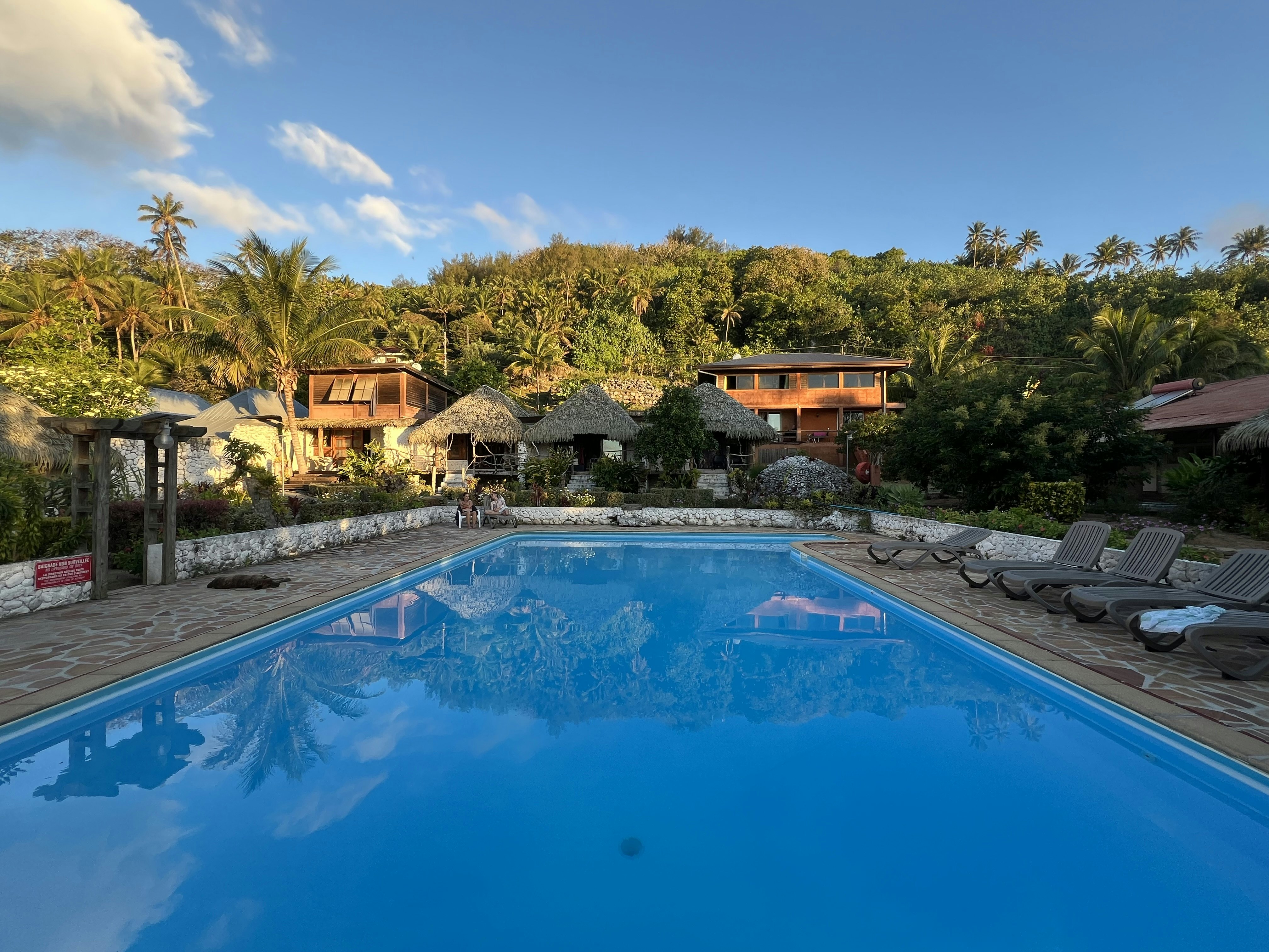 The swimming pool and lounge chairs at Vaitumu Village in Rurutu