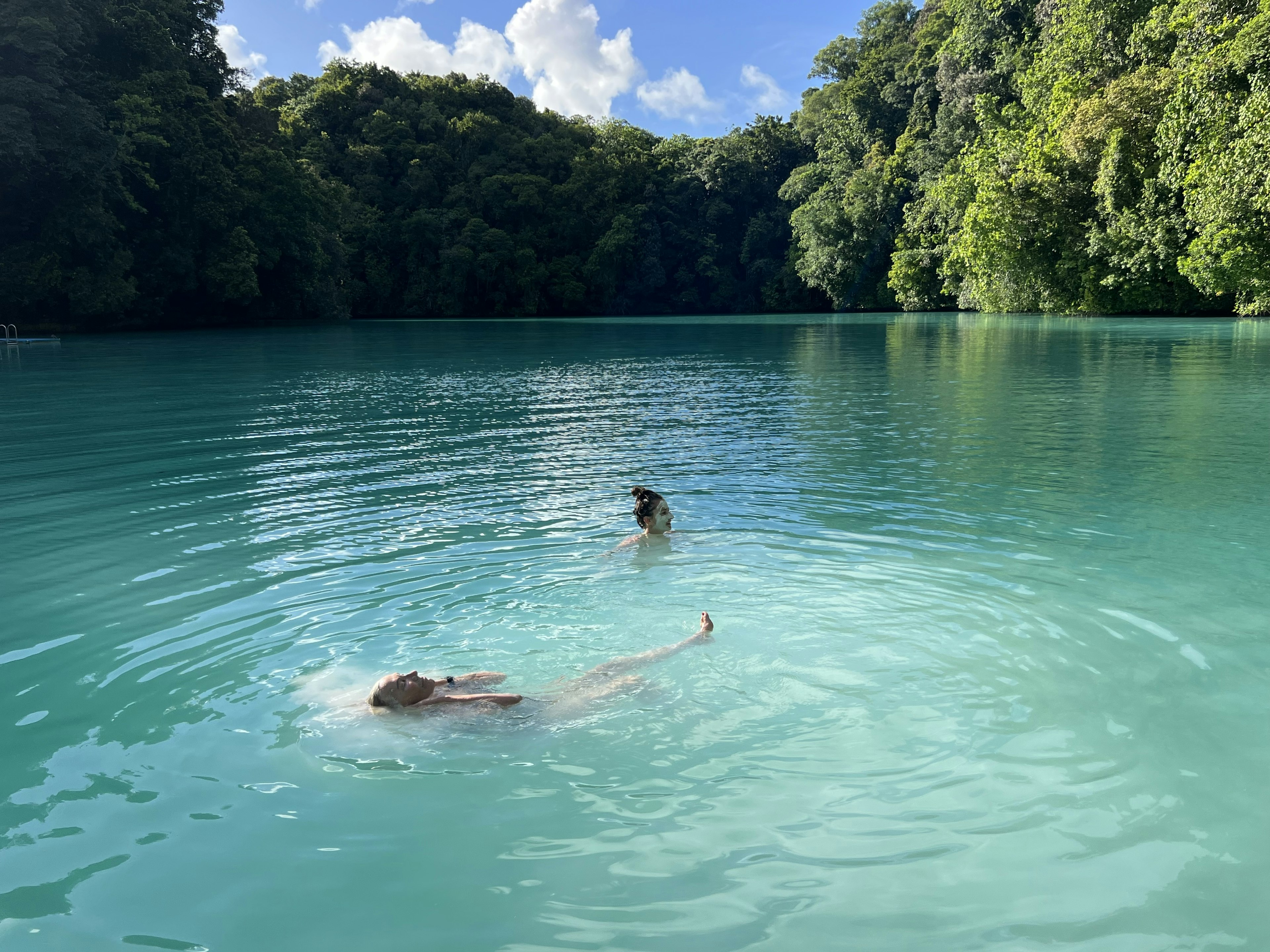 Swimmers smeared with therapeutic mud at Palau's Milky Way lagoon.