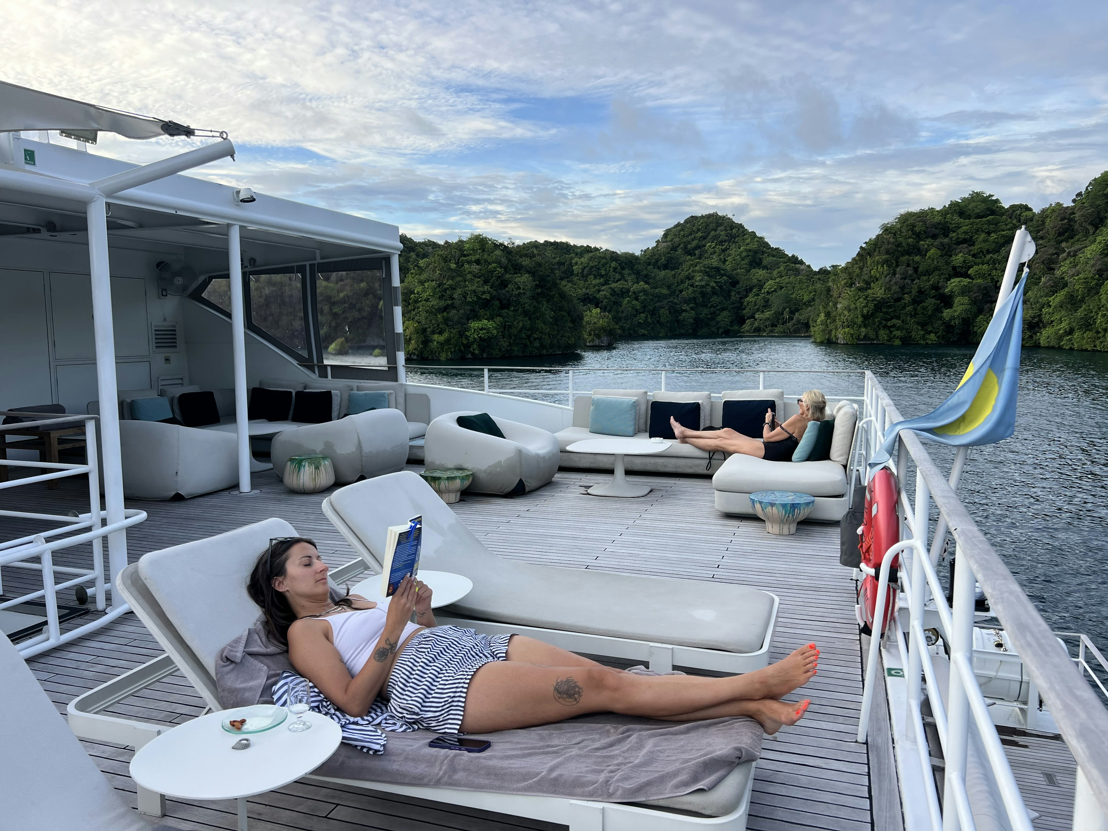 Guests relax aboard the Four Seasons Explorer liveaboard boat in Palau.