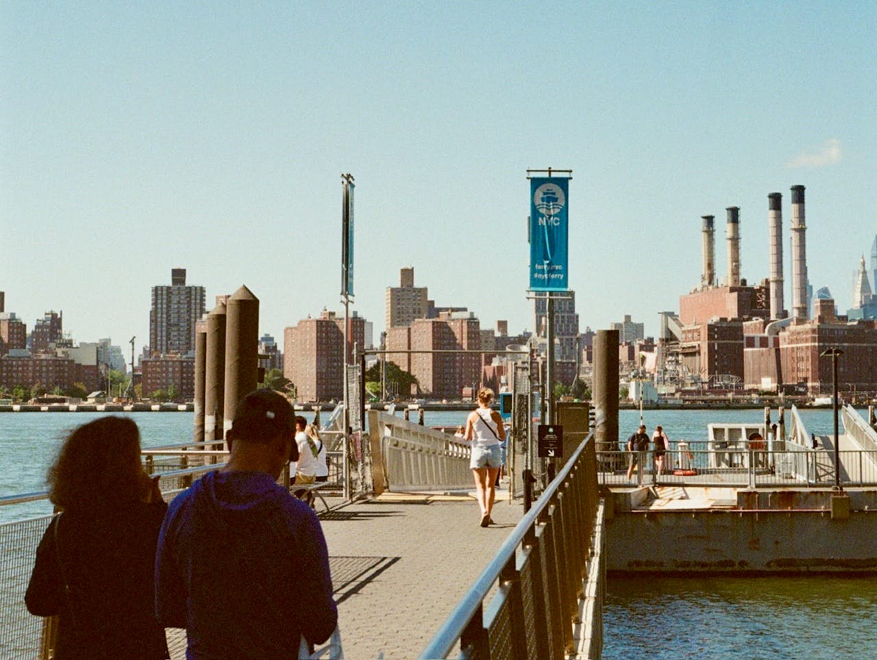 People walking toward a ferry stop 