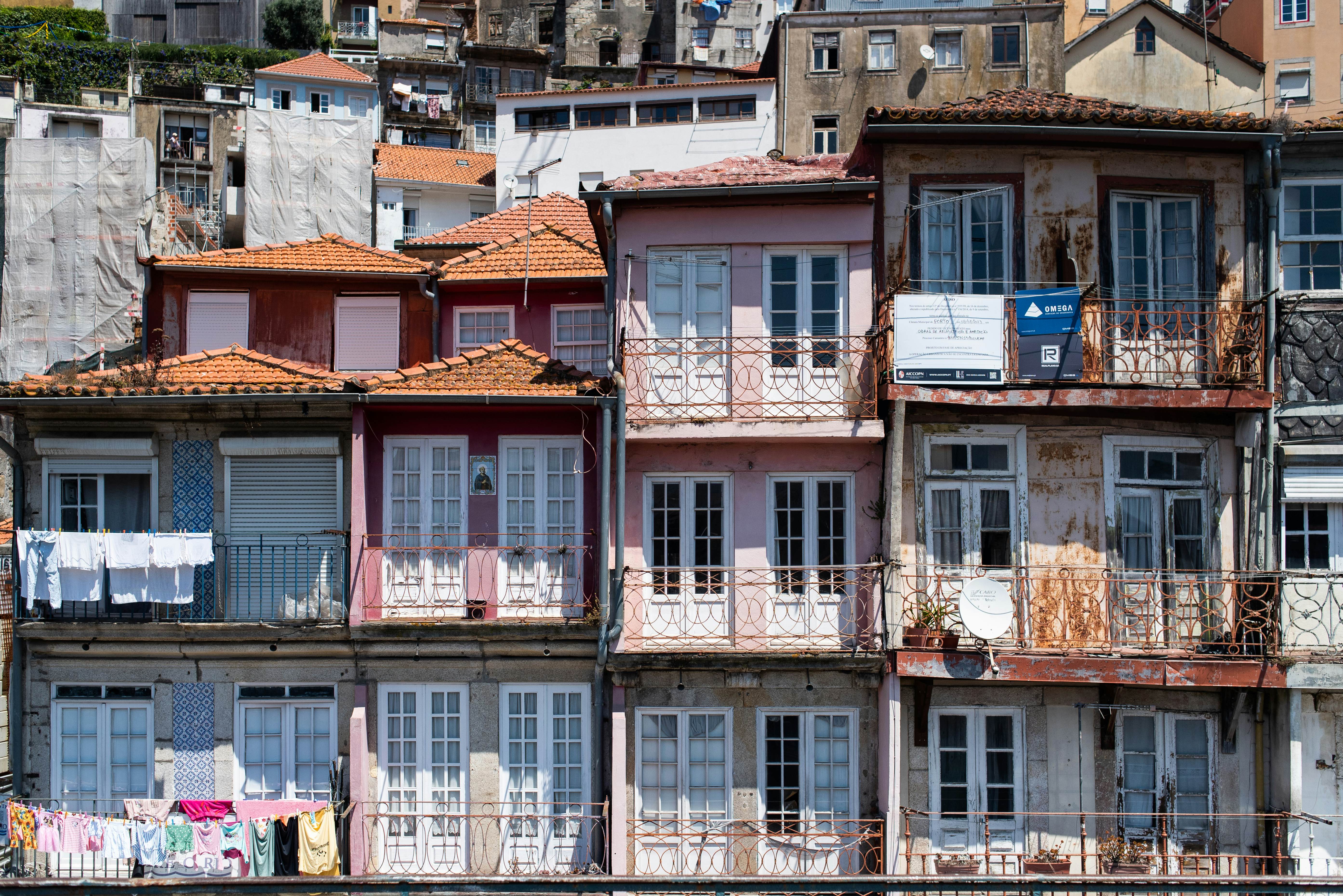 Tightly packed residences with wrought-iron balconies.