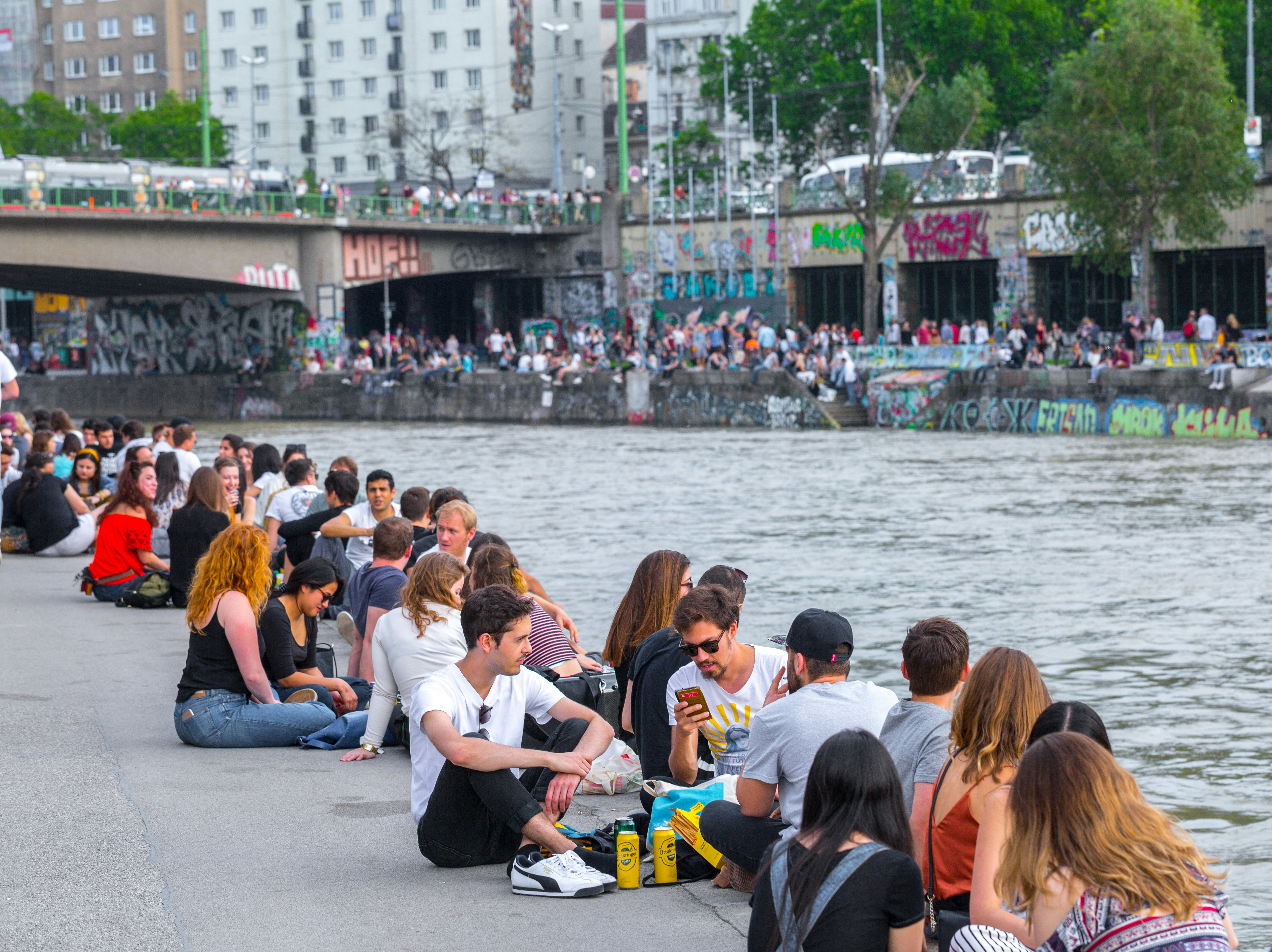 VIENNA, AUSTRIA - MAY 25: Many people are relaxing with alcohol drinks on a day off in a beautiful summer weather on the banks of the Danube Canal(Donaukanal) in Vienna, Austria, on May 25, 2019.