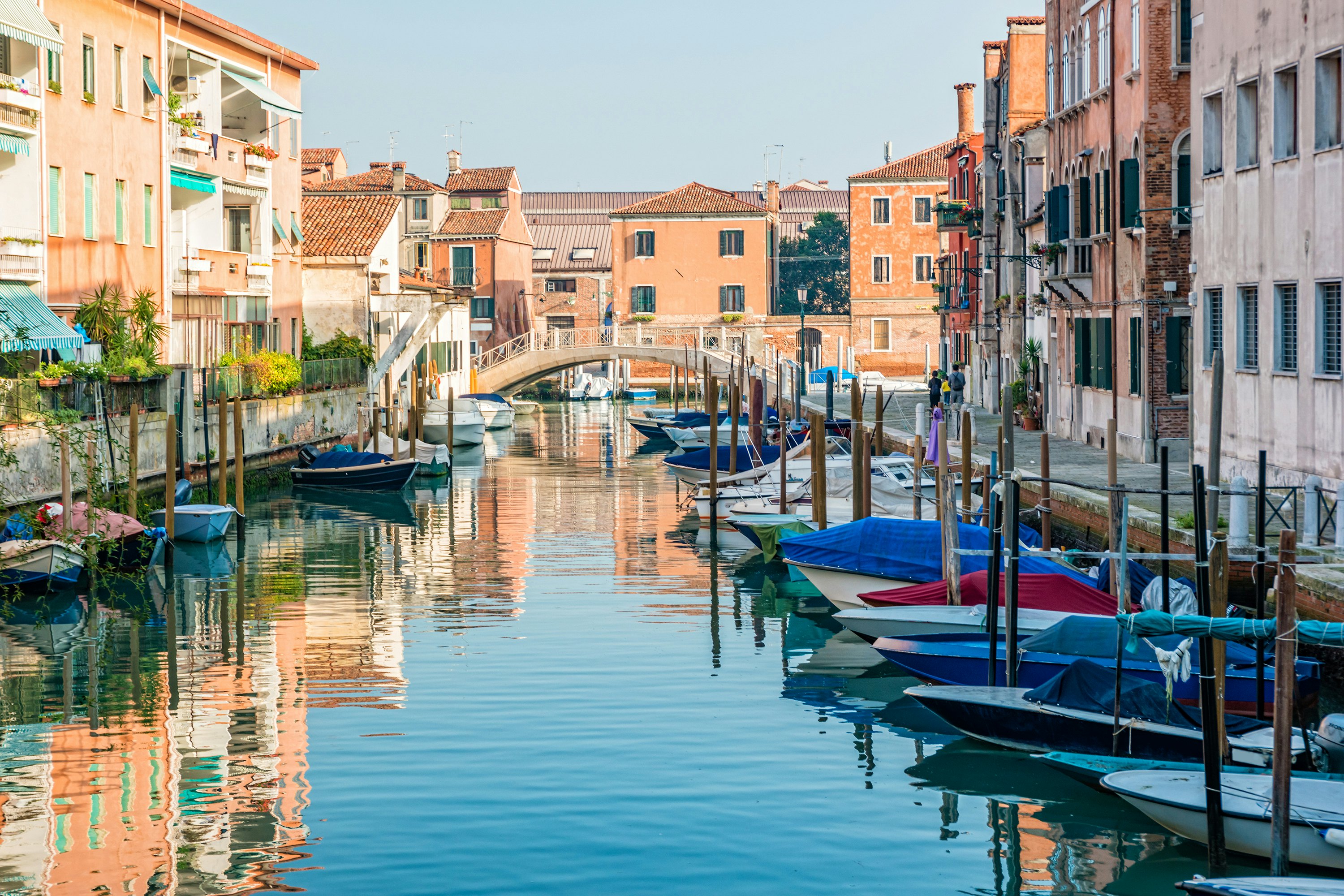 Houses and boats along a quiet canal in Giudecca, Venice, Italy.
