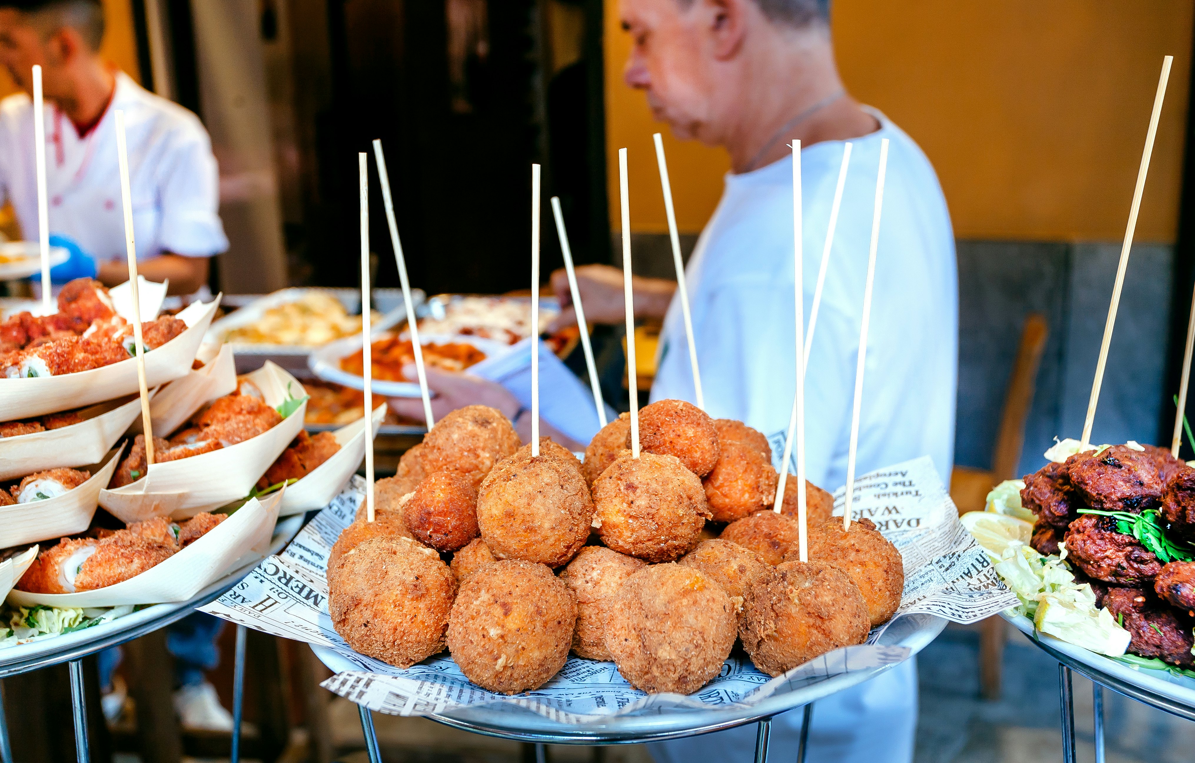 Arancini (rice balls) ready to eat on the go at a food market in Palermo, Sicily.