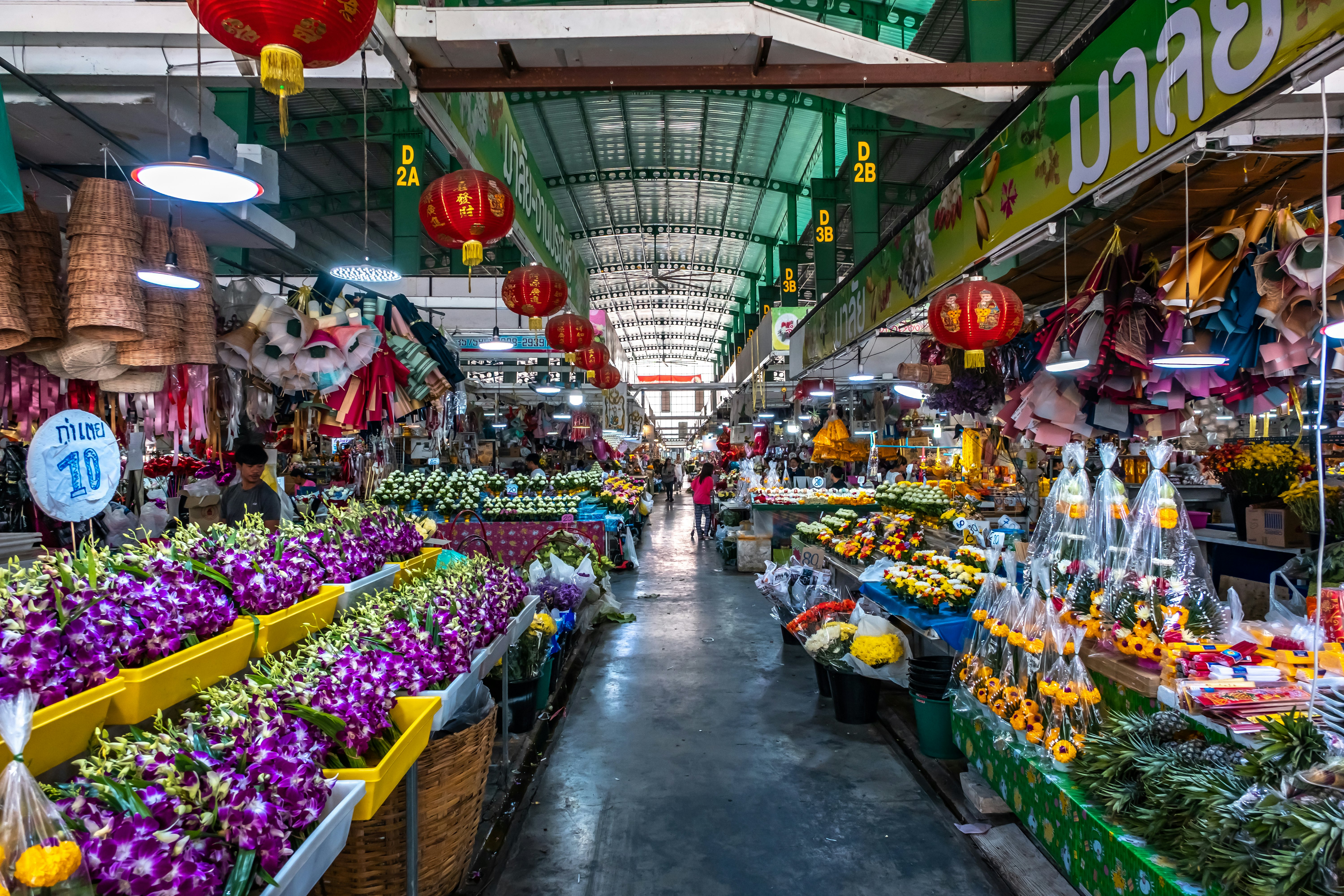 Flowers and orchids line the aisles of the Pak Khlong Flower Market in Bangkok, Thailand.
