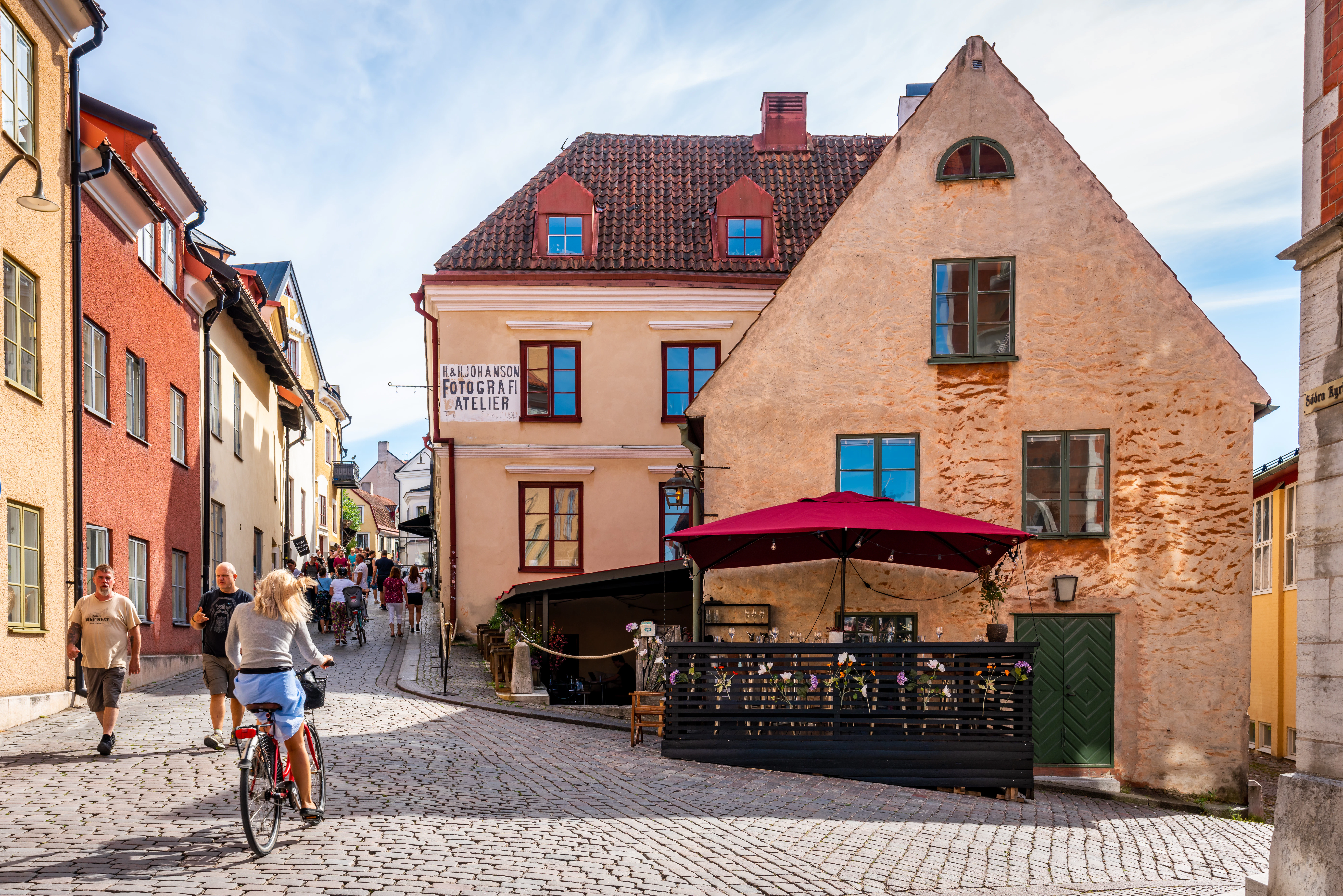 VISBY, SWEDEN: City view of a cafe restaurant on cobblestone street with old ancient buildings in the city of Visby Gotland
