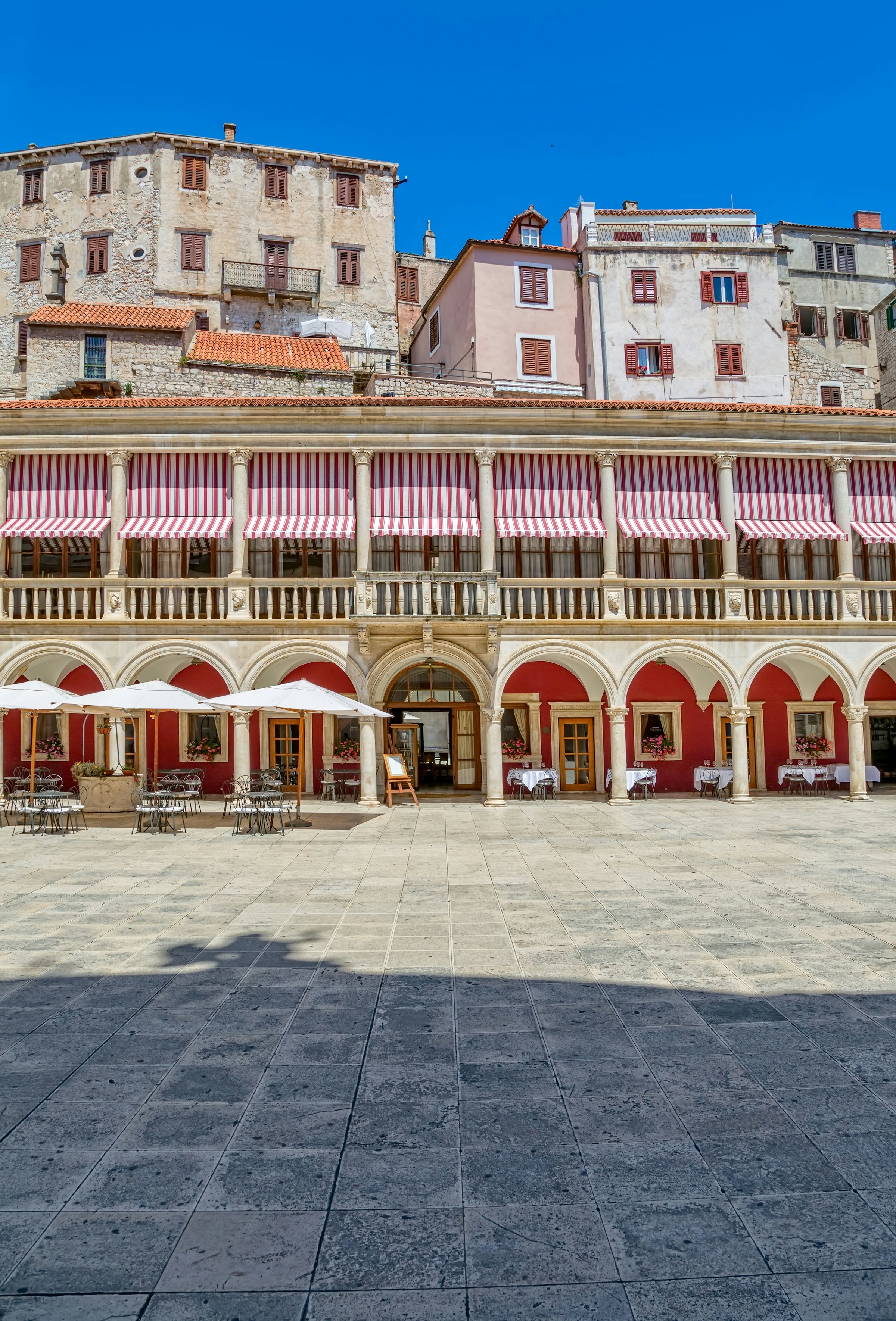 Beautiful view of the old houses, buildings and a restaurant on the Republic square in city center.