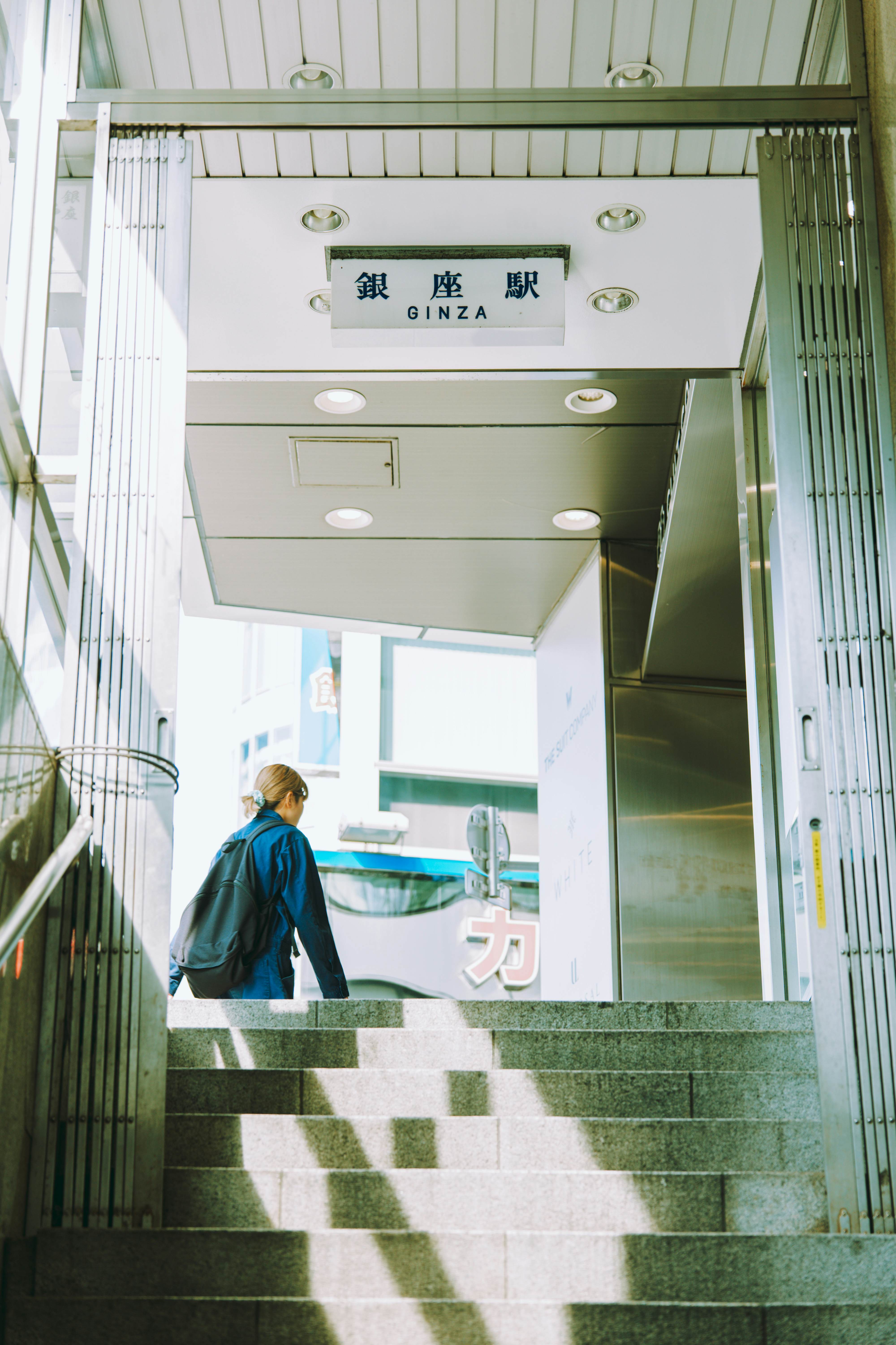 A person at the top of an empty stairwell.