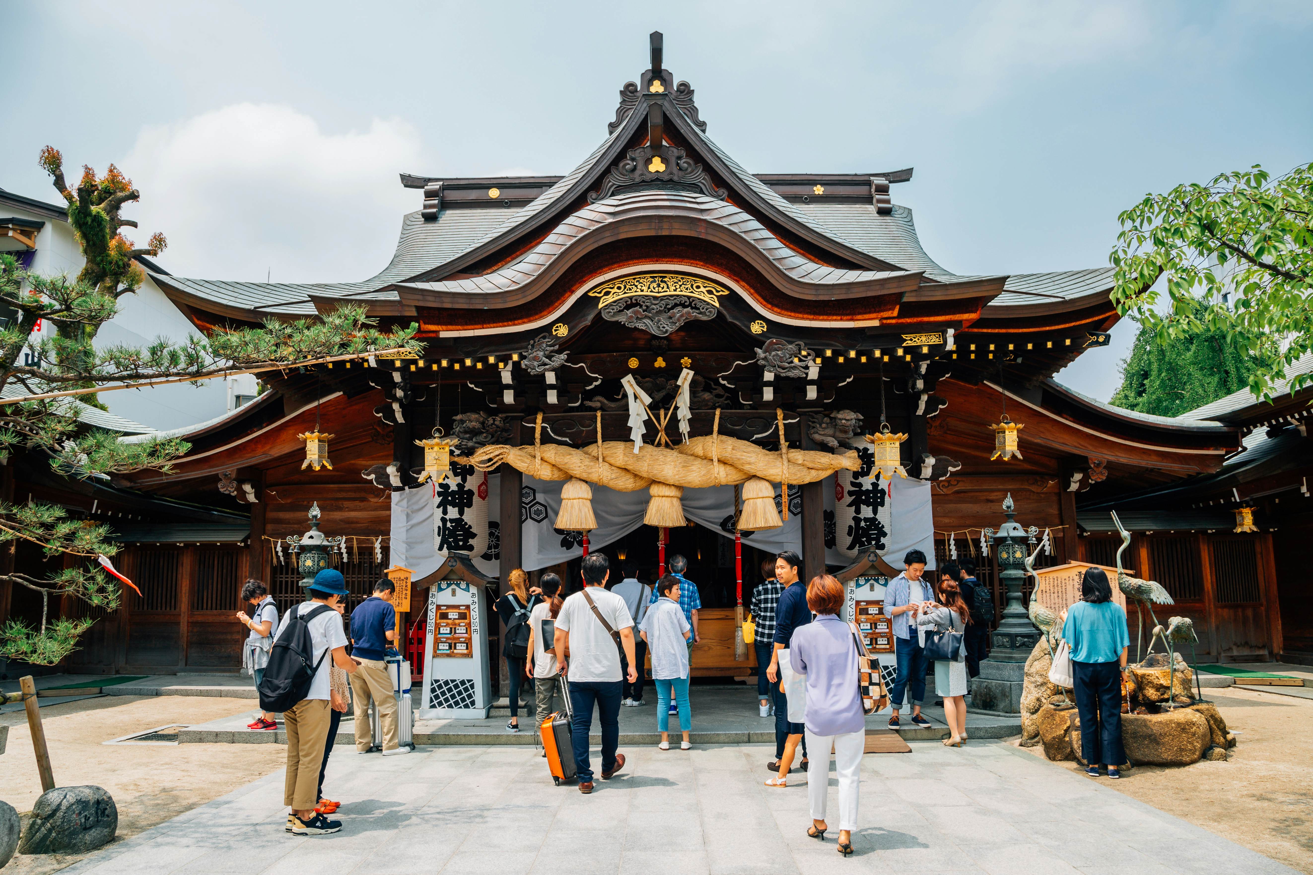 People standing in front of a shrine