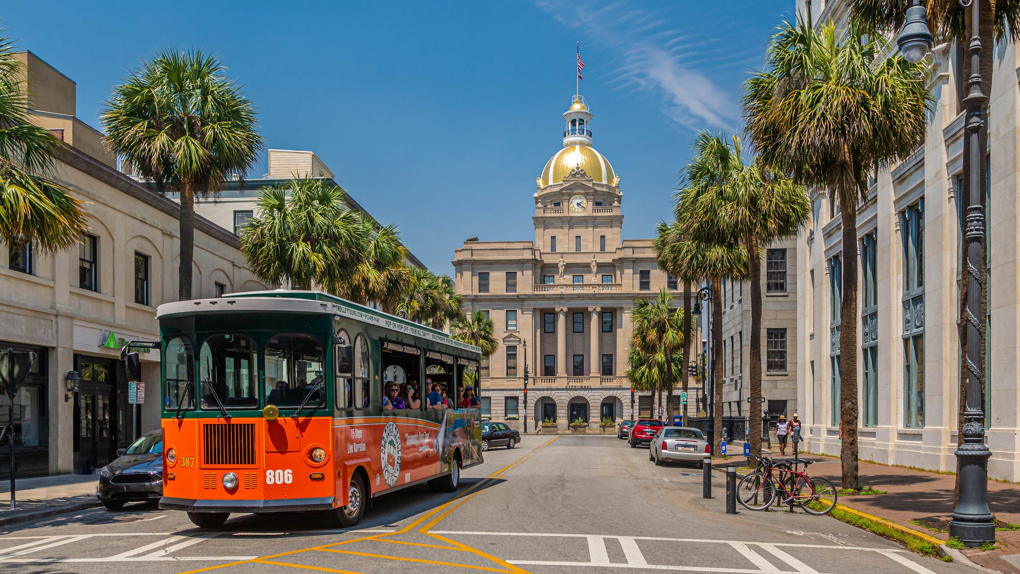 A trolley tour bus rolls through downtown Savannah, Georgia, USA